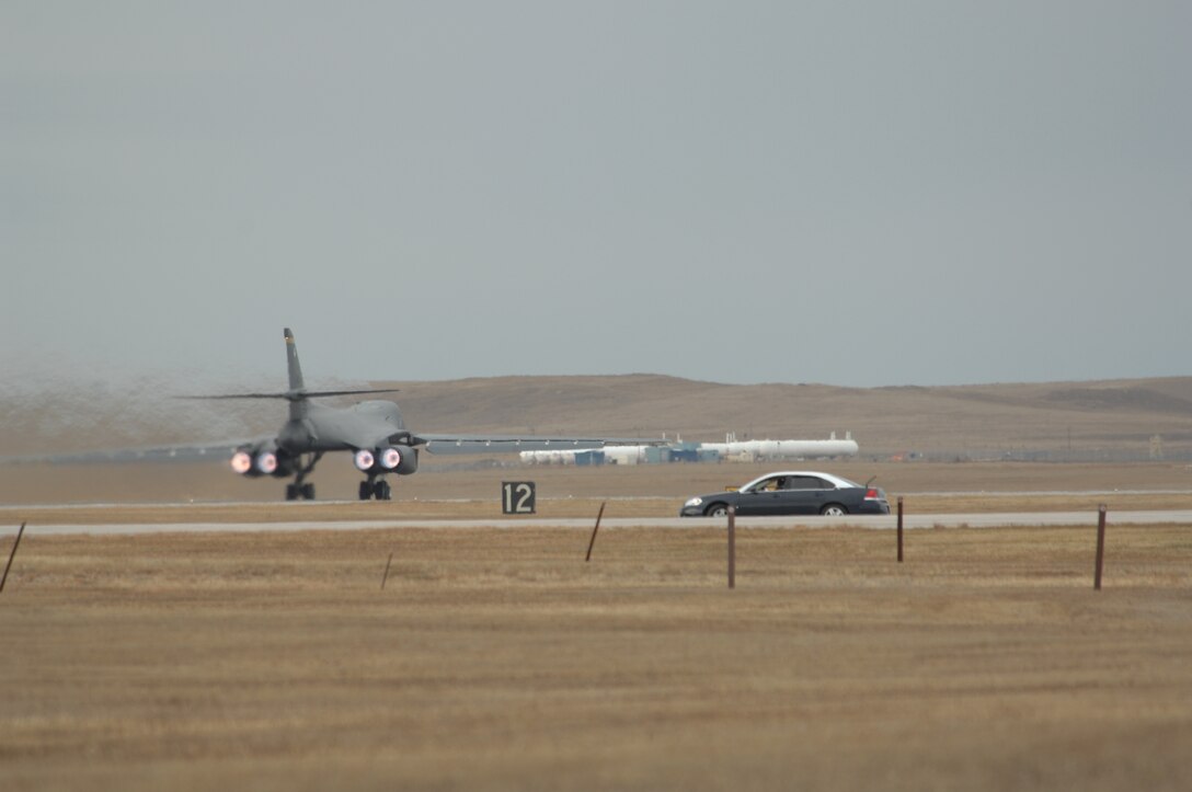 A 37 Bomb Squadron B-1 Bomber begins take off Nov. 16 during the operational readiness inspection as Col. Scott Vander Hamm, 28th Bomb Wing commander, observes from his staff car.  The inspection, which evaluates the base's war-time mission readiness, kicked off Nov. 14 at Ellsworth Air Force Base, S.D. (U.S. Air Force photo/Airman 1st Class Anthony Sanchelli)