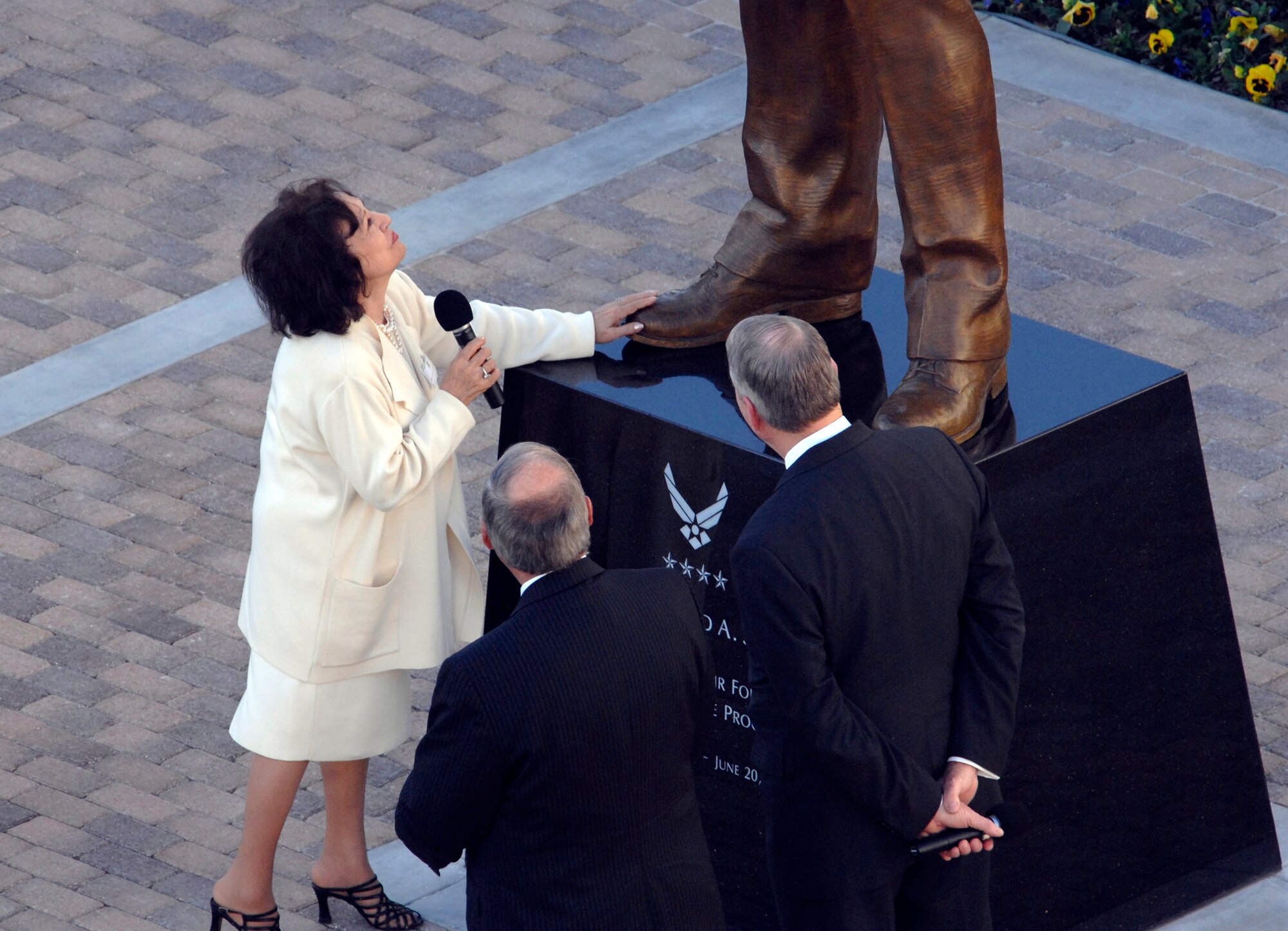 General Bernard A. Schriever’s widow Joni James touches the feet of a statue of her late husband at a ceremony held at Los Angeles AFB, Nov. 15. General Schriever is considered the father of the Air Force’s space and missile program. The statue was donated to SMC by the Air Force Association’s Schriever Chapter. (Photo by Joe Juarez)