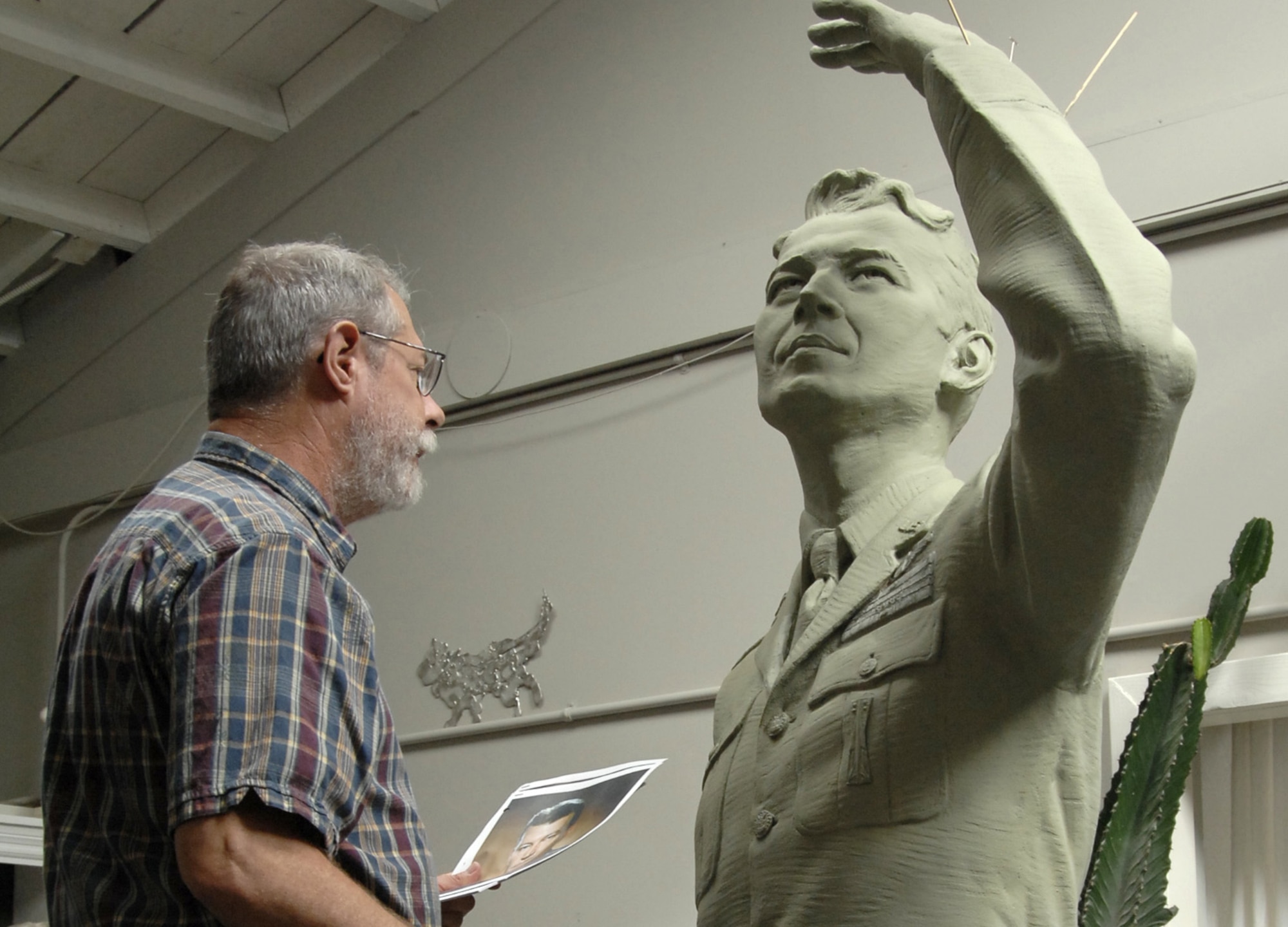 SMC Historian Dr. Harry Waldron inspects the mold of the General Schriever statue. The finished product was dedicated at a ceremony at Los Angeles AFB, Nov. 15. It was donated to SMC by the Air Force Association’s Schriever Chapter. (Photo by Lou Hernandez)