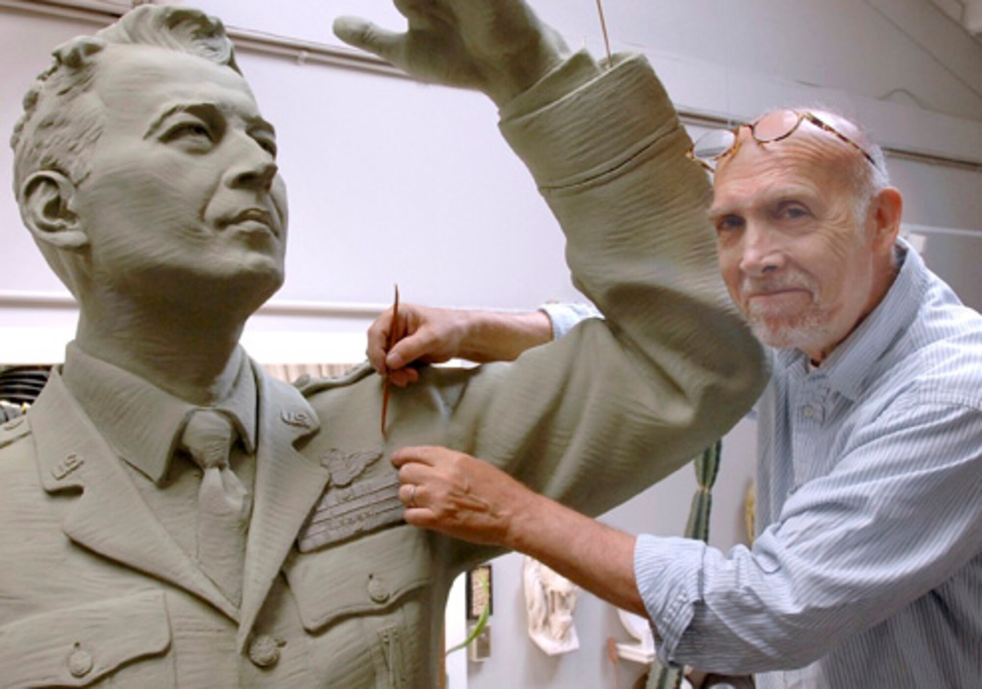 Local sculptor Eugene Daub works on the mold for the General Schriever statue. The finished product was dedicated at a ceremony at Los Angeles AFB, Nov. 15. It was donated to SMC by the Air Force Association’s Schriever Chapter. (Photo by Lou Hernandez)