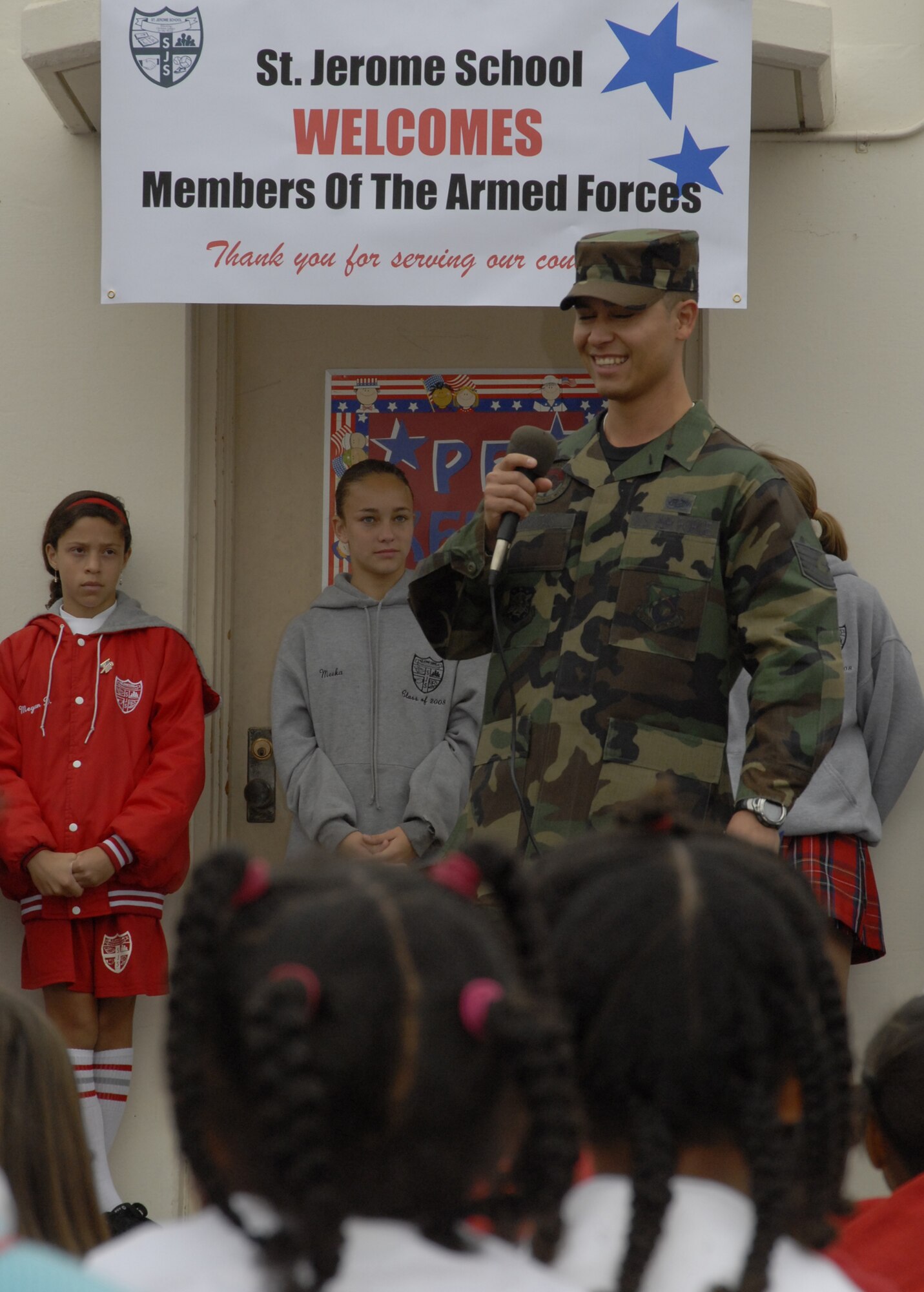 Tech. Sgt. Richard Rositas, Space Superiority Systems Wing, speaks about how all military branches work together at a school assembly at St. Jerome’s Catholic School in Westchester. Approximately 20 military members, including ten Air Force personnel, spoke to students about their military career and the importance of education. (Photo by Joe Juarez)