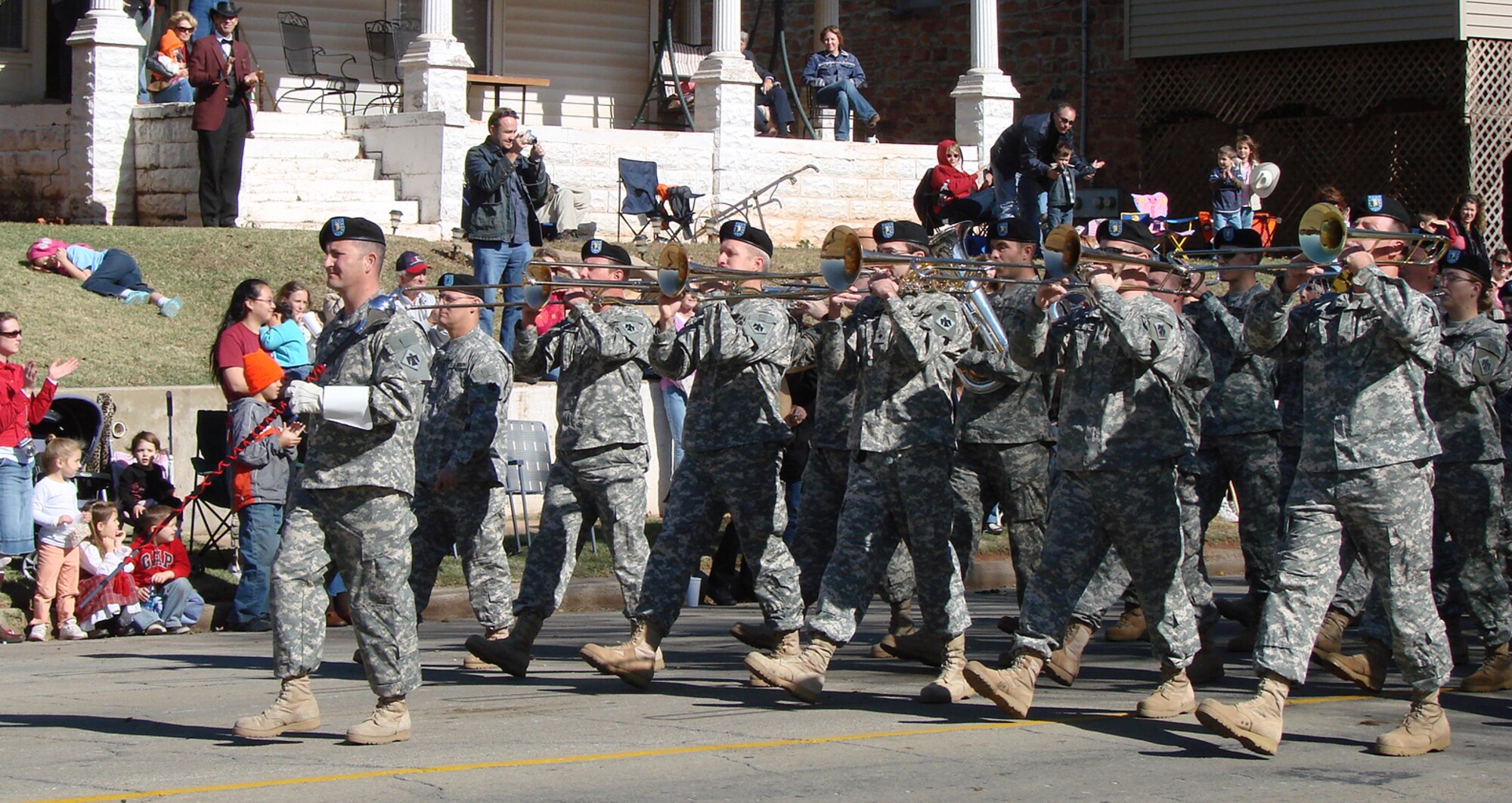 The 145th Army Band from Oklahoma City marches to own their tune during the Oklahoma Centennial parade Nov. 16 at Guthrie, Okla. The band followed the Vance Air Force Base T-38C flyover that kicked off the parade. (U.S. Air Force photo by Tech. Sgt. Mary Davis)