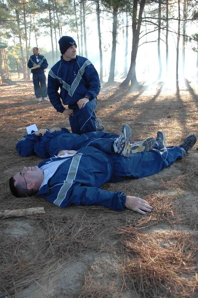 SHAW AIR FORCE BASE, S.C. -- A member of the 20th Fighter Wing provides first aid to people with simulated injuries as part of a Major Accident Response Exercise (MARE) on Nov. 16. The MARE tests the capability of Airmen to respond to an accident, disaster or catastrophe, such as a plane or car crash, explosion or attack. (U.S. Air Force photo/Staff Sgt. Henry L. Hoegen Jr.)