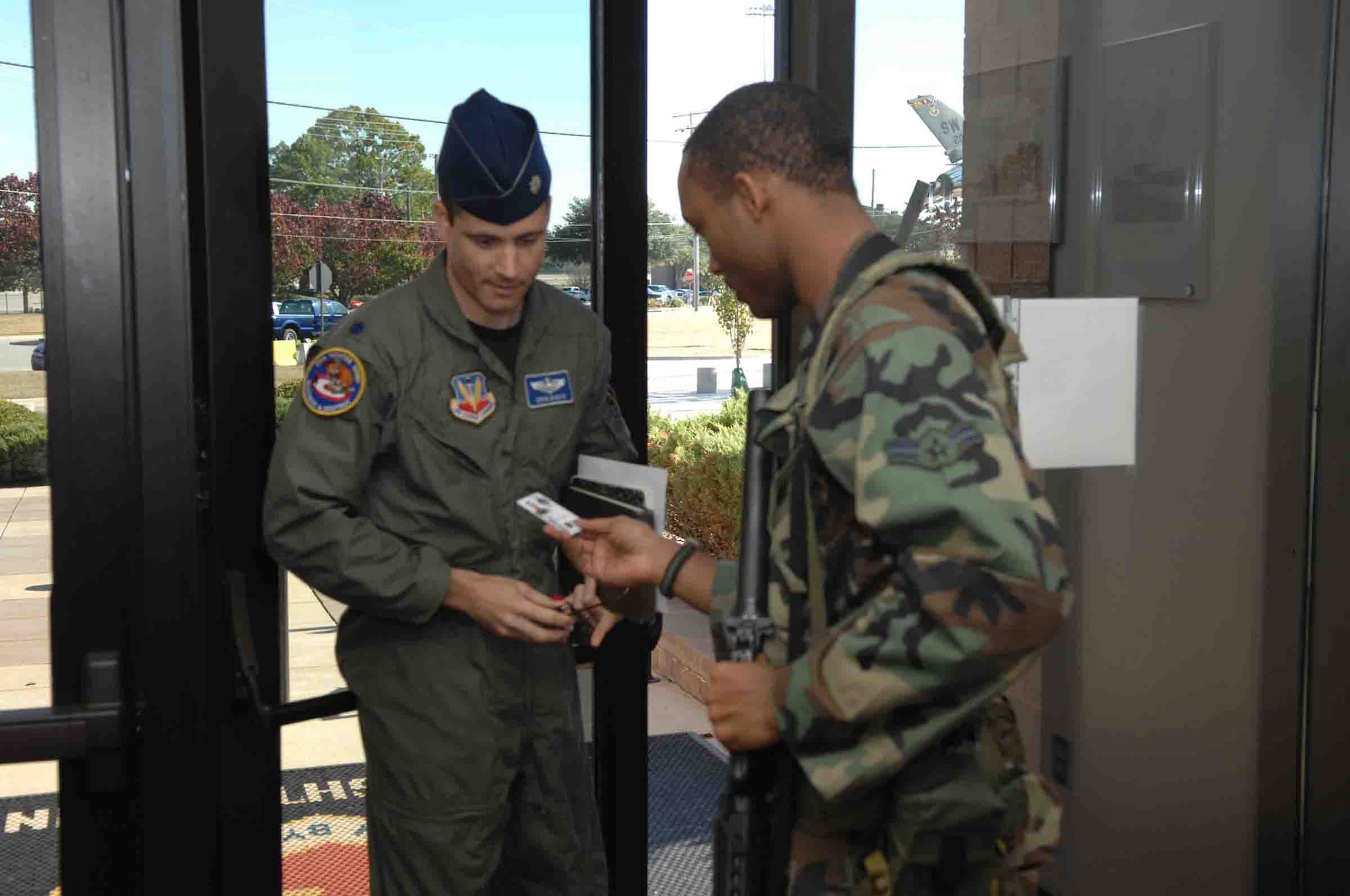 SHAW AIR FORCE BASE, S.C. -- Airman 1st Class Mychel Barker, 20th Logistics Readiness Squadron materiel management, checks the identification card of those entering the Wing Headquarters building as part of a Major Accident Response Exercise (MARE) on Nov. 16. The MARE tests the capability of Airmen to respond to an accident, disaster or catastrophe, such as a plane or car crash, explosion or attack. (U.S. Air Force photo/Staff Sgt. Henry L. Hoegen Jr.)