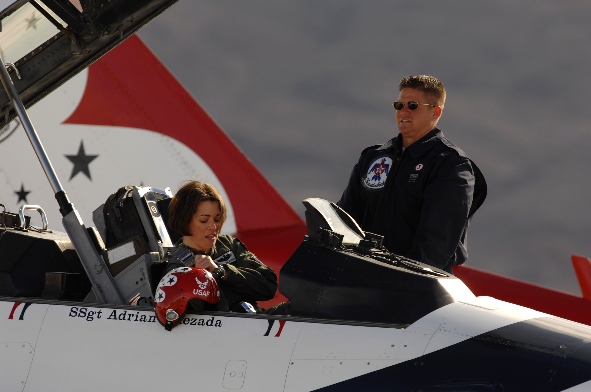 Maj. Nicole Malachowski prepares to take off for a practice sortie with the Thunderbirds in an F-16 Fighting Falcon as Staff Sgt. Steve Wyatt assists. Major Malachowski is the Thunderbird #3 right wing pilot and just finished her two-year tour with the Air Force Demonstration Squadron. Sergeant Wyatt is the Thunderbird #3 crew chief. (U.S. Air Force photo/Staff Sgt. Kristi Machado) 
