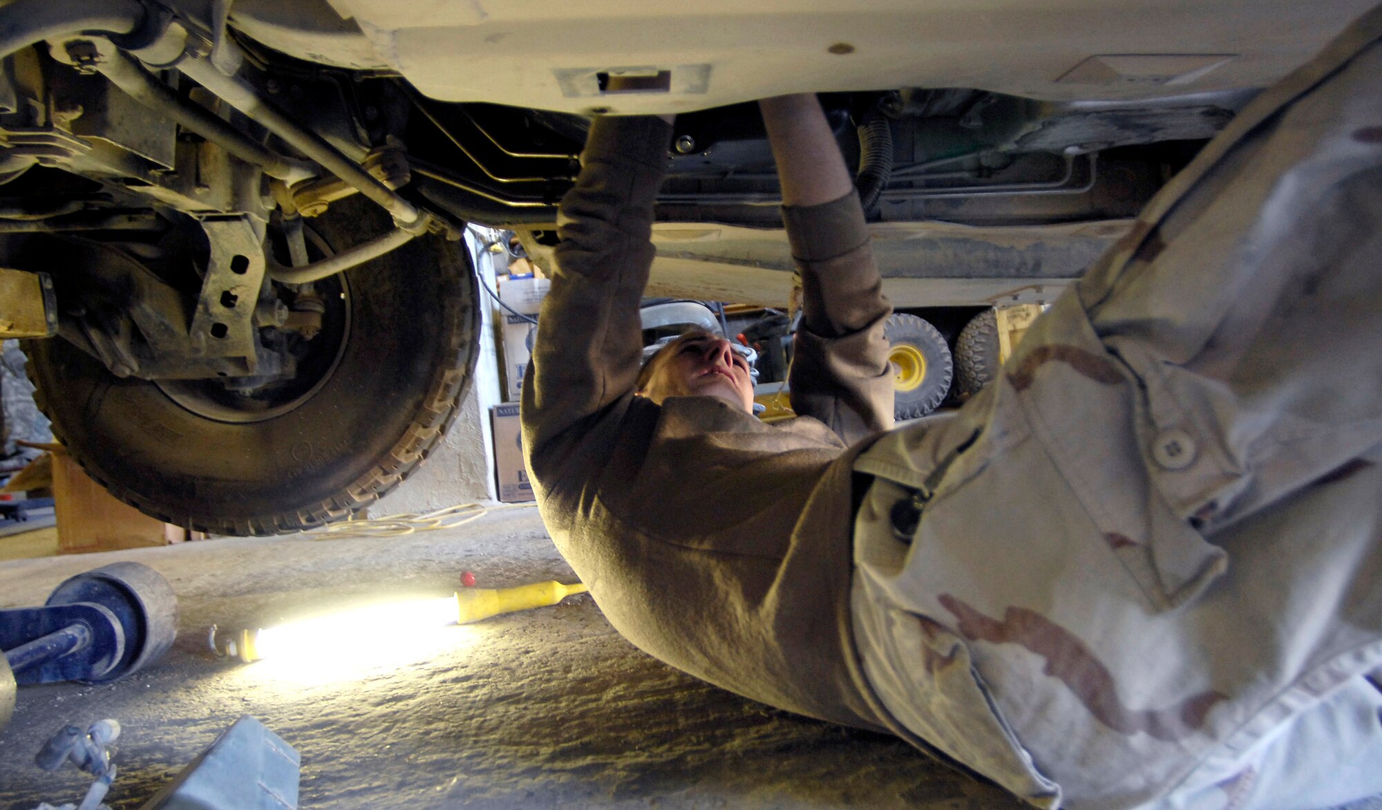 Staff Sgt. Joel Bonnett works on the transfer case of a Humvee Nov. 1 at forward operating base Lagman, Afghanistan. Sergeant Bonnett is a vehicle maintenance technician filling a 365-day Army 'in-lieu-of' tasking. Sergant Bonnett is deployed from Fort Riley, Kans. (U.S. Air Force photo/Staff Sgt. Brian Ferguson)