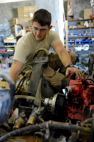 FORWARD OPERATING BASE LAGMAN, Afghanistan - Technical Sgt. Dave Albanese hooks up the lift pump on a Humvee Nov. 1 at Forward Operating Base Lagman, in Afghanistan. Sergeant Albanese is a vehicle maintenance technician filling a 365-day Army 'in-lieu-of' tasking. Sergeant Albanese is deployed from Seymour Johnson Air Force Base, N.C. (U.S. Air Force photo/Staff Sgt. Brian Ferguson) 