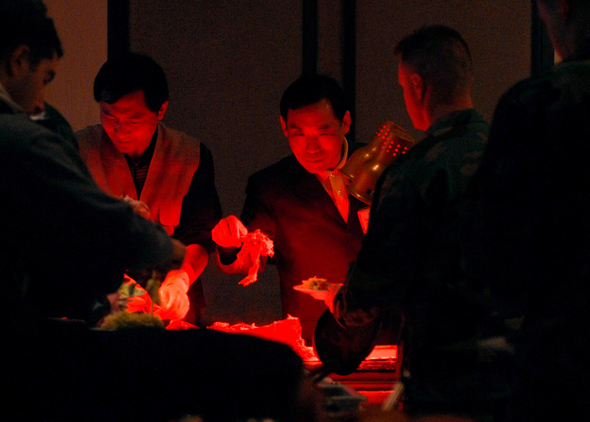 Honorary commanders serve roasted pig to 8th Fighter Wing Airmen here Nov. 12. More than 60 honorary commanders held a friendship day for approximately 400 Wolf Pack Airmen to increase relationships between the base and local community. (U.S. Air Force photo/Staff Sgt. Araceli Alarcon)