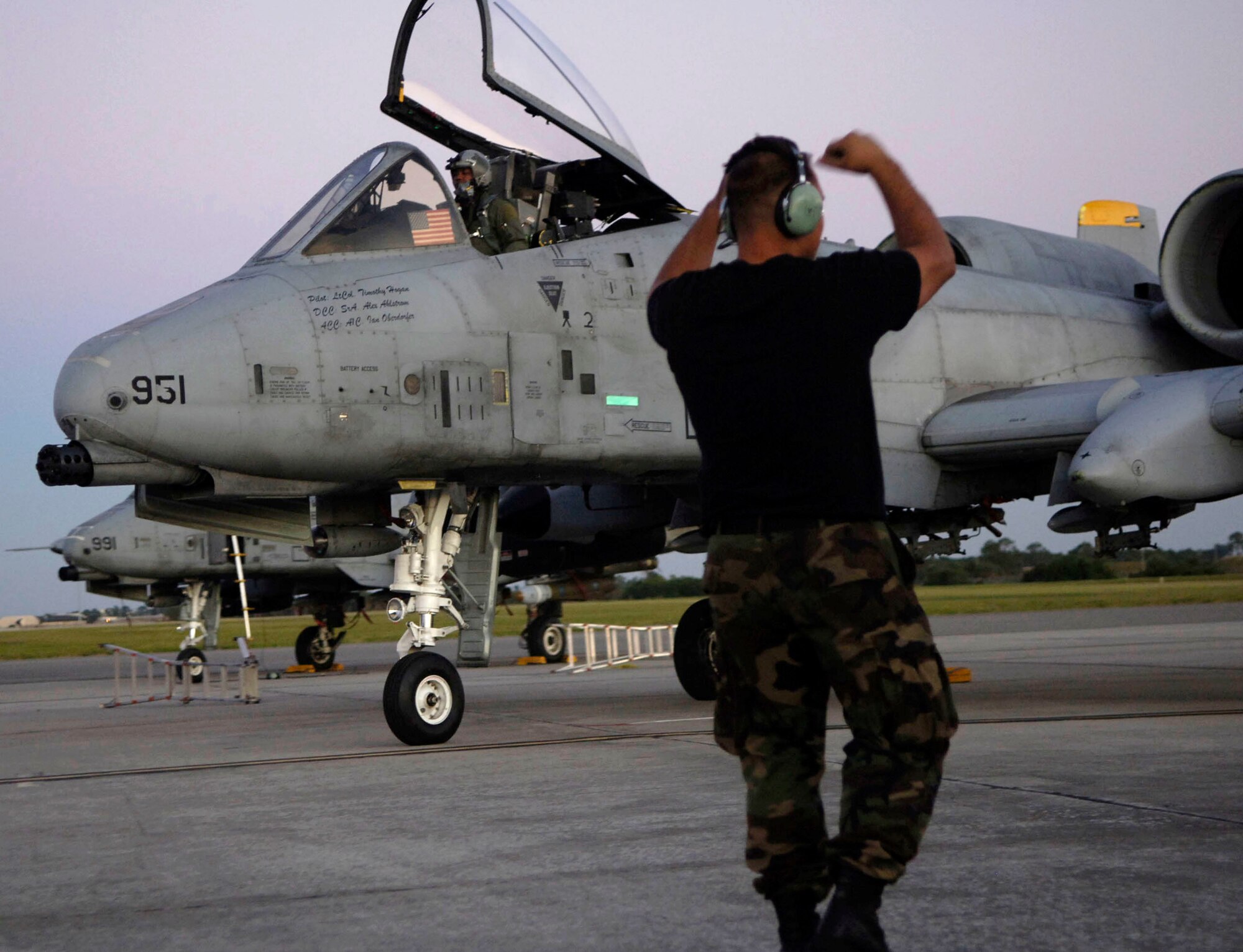 Senior Airman Alexander Ahlstrom directs an A-10 Thunderbolt II toward the aircraft taxi lane before takeoff Nov. 7 from MacDill Air Force Base, Fla. The A-10 is deployed to MacDill AFB to support exercise Atlantic Strike VI in Avon Park, Fla. Atlantic Strike is a U.S. Central Command Air Forces-sponsored exercise focusing on urban close-air-support operations. Airman Ahlstrom is a crew chief from Spandahlem Air Base, Germany. (U.S. Air Force photo/Airman 1st Class Stephenie Wade) 
