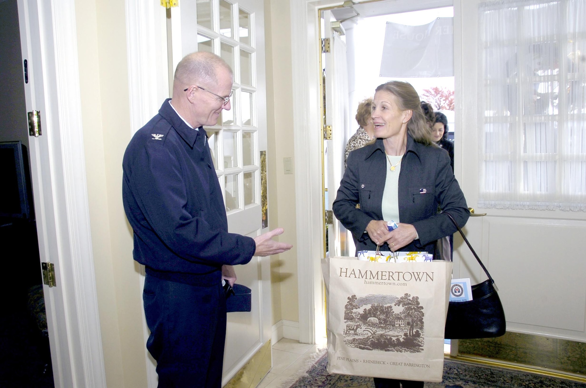 Col. Paul R. Ackerley, 316th Wing commander, greets Mrs. Audrey Fisher during her visit to the Fisher House Nov. 8. Mrs. Fisher toured Andrews squadrons and facilities, including the Executive Airlift Training Center, Aeromedical Staging Flight, 89th Operations Support Squadron and received a military working dog demonstration performed by the 316th Security Forces Squadron. (US Air Force/Bobby Jones)