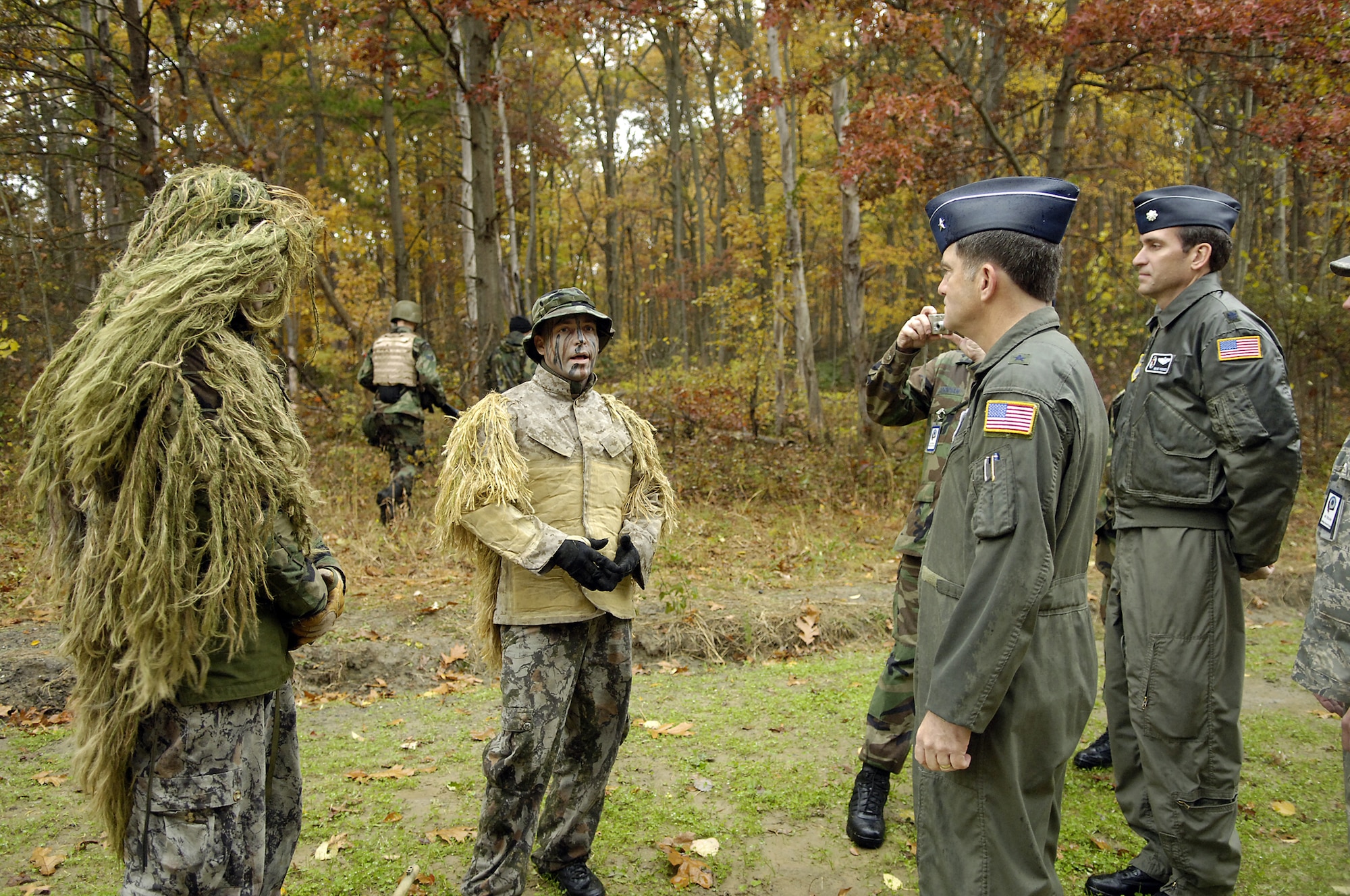 Brig. Gen. Donald Lustig, Air Mobility Commaner Inspector General, is briefed by Senior Airman George Reinas and Tech. Sgt. Robert Mitchell about the Expeditionary Combat Skills Training Course taught  at Fort Dix. Mitchell and Reinas are members of the Close Precision Engagement Team that assists the ECST. The ECST is taught by the 305th Security Forces Squadron to prepare McGuire members for deployment in AEF rotations. (U.S. Air Force photo / Kenn Mann.)