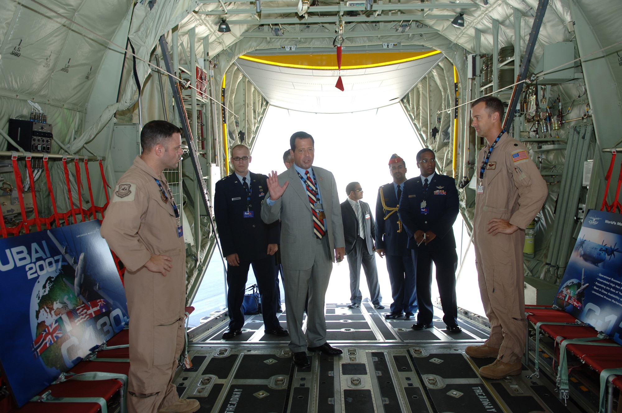 Deputy Under Secretary of the Air Force Bruce Lemkin talks to Tech. Sgt. Steve Nader (left) and Lt. Col. Jeff Gast during a tour of a C-130 Hercules at the Dubai Air Show Nov. 12. Colonel Gast and Sergeant Nader are assigned to the 41st Airlift Squadron at Little Rock Air Force Base, Ark. The United States military provided support for the 10th annual Dubai Air Show Nov. 11 to 15. Approximately 300 Airman, Soldiers and Sailors, and various Air Force and Navy aircraft from bases in the Persian Gulf region and the United States exhibit a snapshot of the U. S. military's diverse aircraft inventory. The air show was an opportunity to build relationships with allied partners. (U.S. Air Force photo/Tech. Sgt. Charlein C. Sheets)