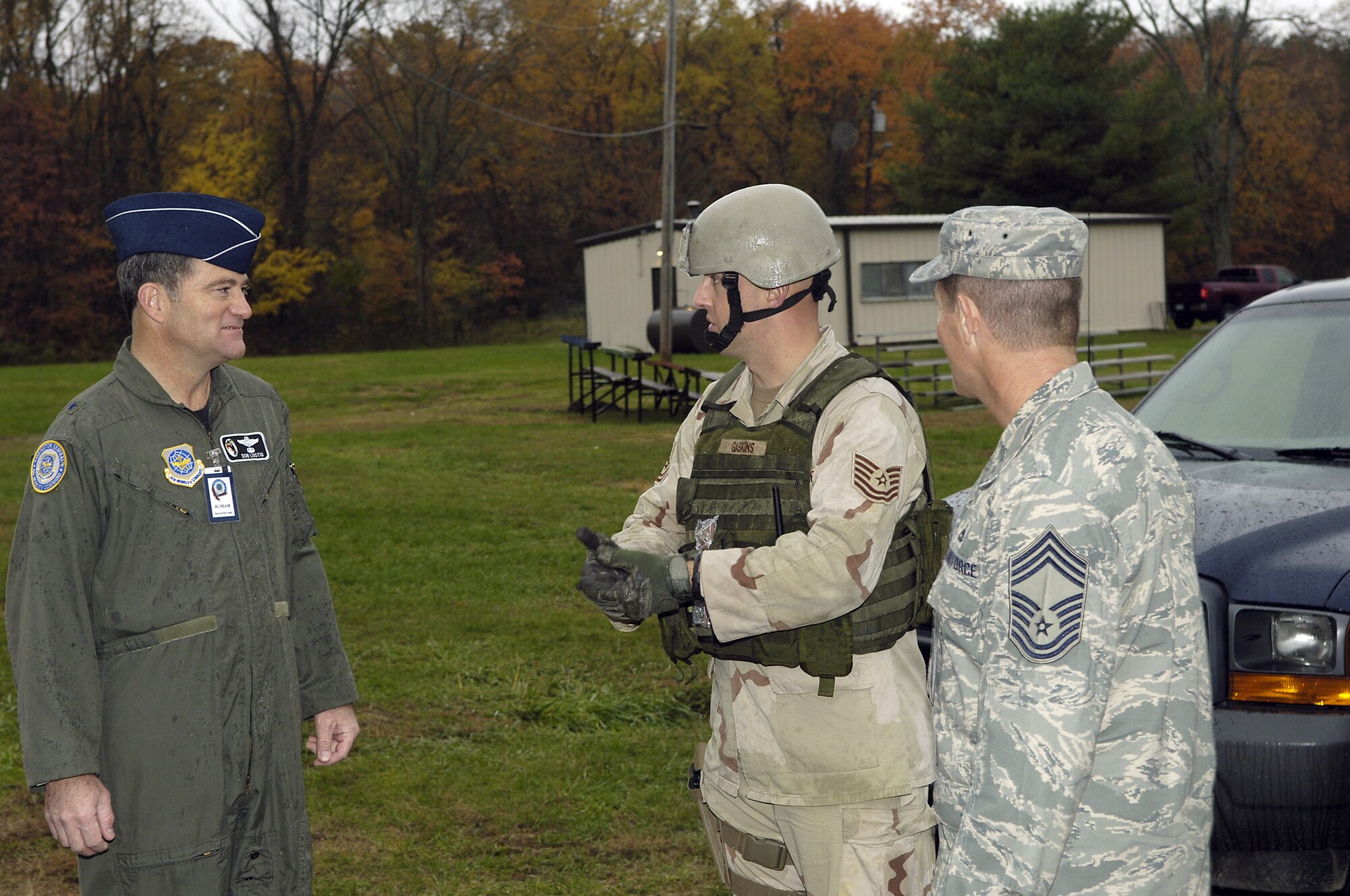 Tech. Sgt. William Gaskins (center) briefs Brig. Gen. Donald Lustig, Air Mobility Commander Inspector General, and Chief Master Sgt. David Popp about the Expeditionary Combat Skills Training Course taught on Fort Dix. Sergeant Gaskins is the Program Manager for the ECST course. The ECST is taught by the 305th Security Forces Squadron to prepare McGuire members for deployment in AEF rotations. Chief Popp is a former command chief for McGuire AFB. (U.S. Air Force photo / Kenn Mann.)