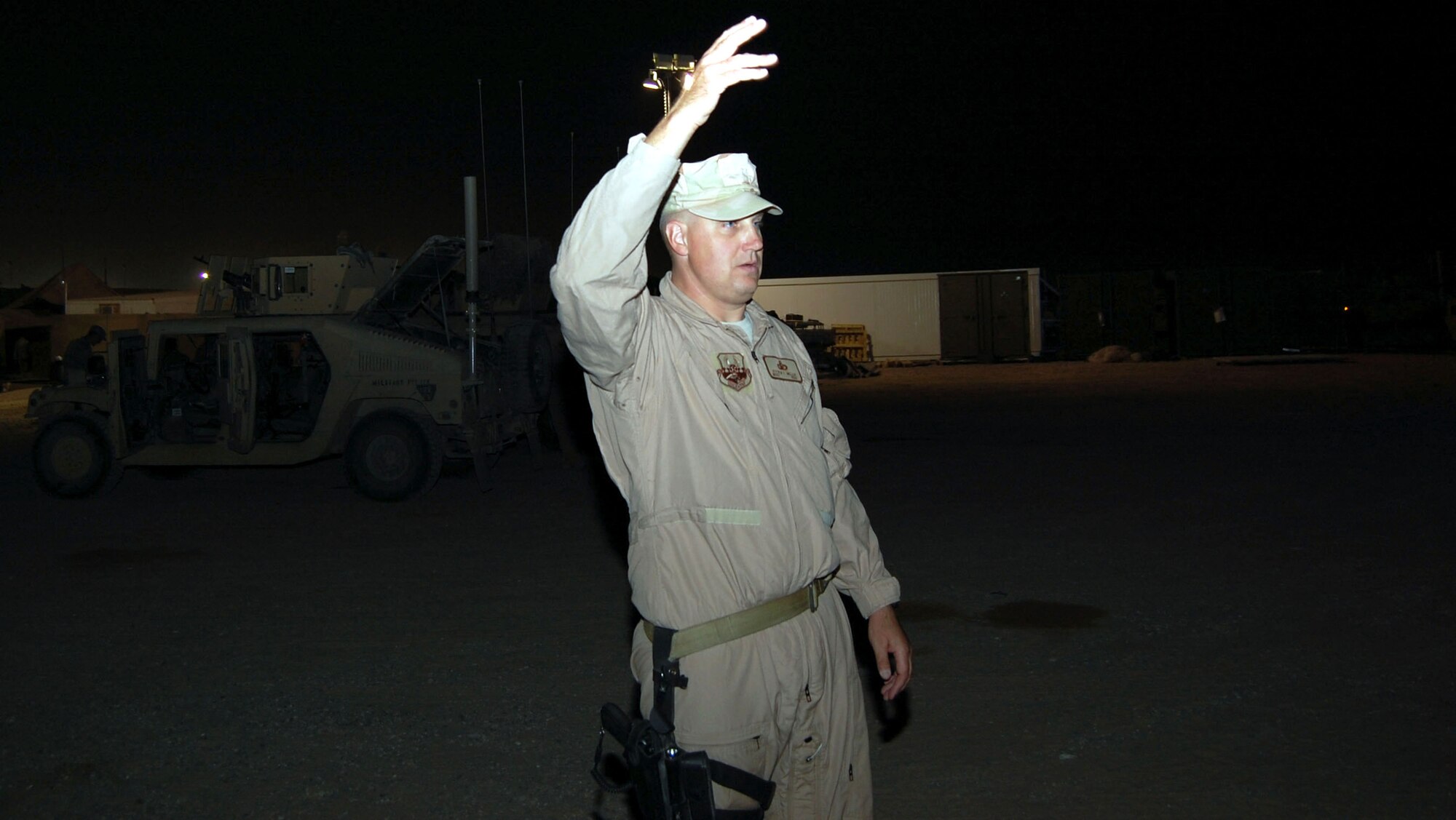Master Sgt. Steven Miller gives the signal to move a convoy out Nov. 12 at Camp Bucca, Iraq. Sergeant Miller, an 887th Expeditionary Security Forces convoy commander, is from Moody Air Force Base, Ga. (U.S. Air Force photo/Staff Sgt. Phillip Butterfield) 
