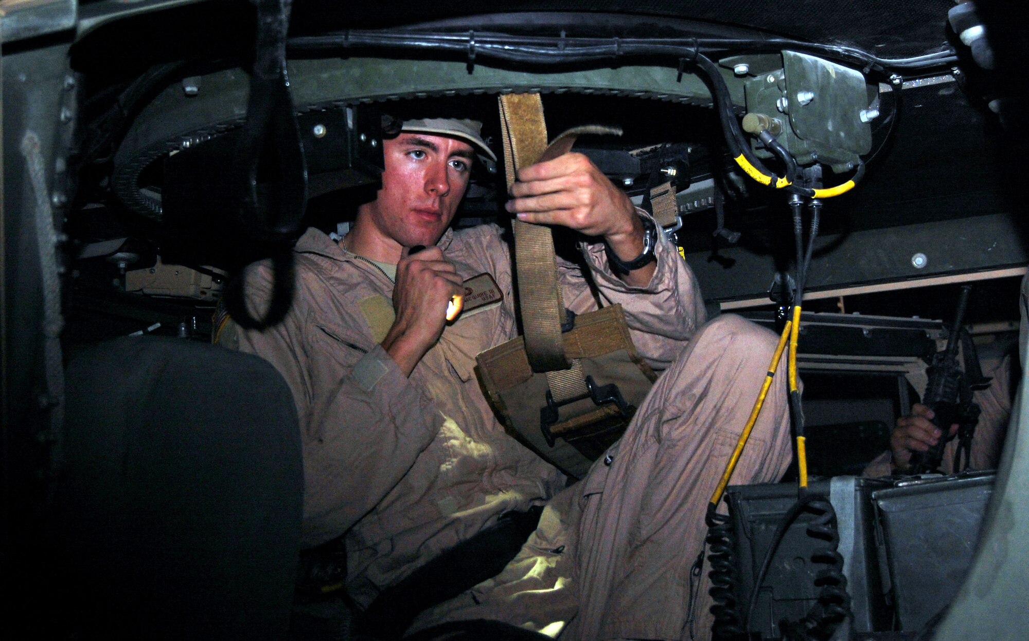 Airman 1st Class Byron Mcguire inspects the straps on the turret seat prior to a convoy mission Nov. 12 at Camp Bucca, Iraq. Airman Mcguire, an 887th Expeditionary Security Forces Cobra Squad gunner, is from Moody Air Force Base, Ga. (U.S. Air Force photo/Staff Sgt. Phillip Butterfield) 
