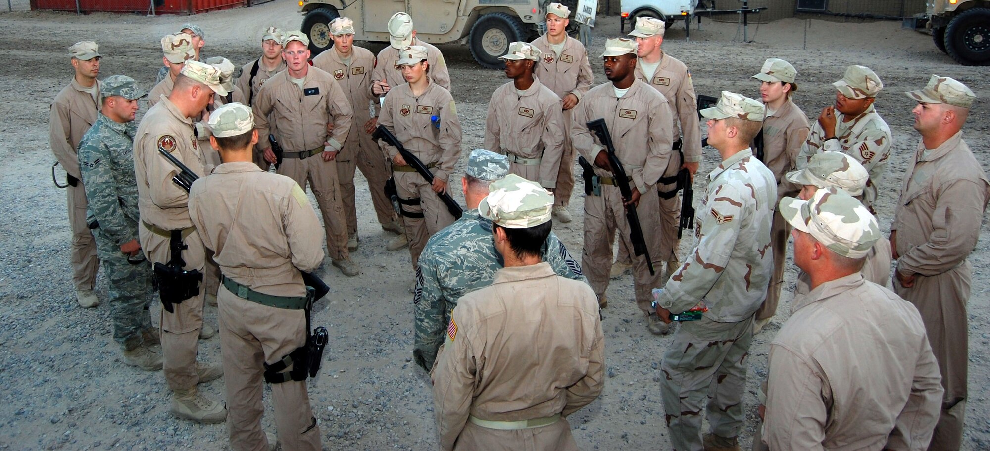 Fire teams from cobra and punisher squads come together to receive a convoy premission briefing Nov. 12 at Camp Bucca, Iraq. The two squads represent Airmen from Barksdale Air Force Base, La., Nellis AFB, Nev., Lackland AFB, Texas, and Moody AFB, Ga. (U.S. Air Force photo/Staff Sgt. Phillip Butterfield) 
