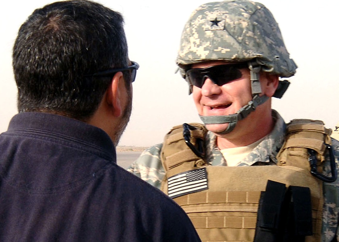 An Office of Special Investigation Det. 2408 agent greets Brig. Gen. Dana Simmons upon his arrival at Sather Air Base, Iraq, last month. During the visit, the general met with AFOSI detachments on Victory Base Complex to hear first-hand accounts about their missions. General Simmons is the Air Force Office of Special Investigations commander. (U.S. Air Force photo/Staff Sgt. Jennifer Lindsey) 