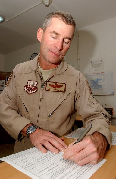 Col. Matthew Dorschel signs up for an EagleCash card Nov. 12. at Ali Air Base, Iraq. The base was the last stop for the EagleCash program to be implemented in southern Iraq. The EC program provides instant access to funds electronically which potentially saves lives and thousands of dollars to transport hard currency in the area of responsibility. Colonel Dorschel is the 407th Air Expeditionary Group commander and is deployed from Hickam Air Force Base, Hawaii. (U.S. Air Force photo/Airman 1st Class Jonathan Snyder) 
