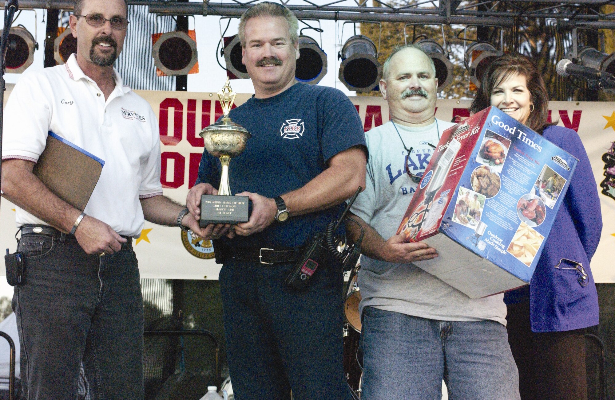 The base fire department team is presented their first place trophy and award for the chili cook-off. The 452nd Services Squadron hosted the first  Autumn Nights Car Show and Chili Cook-Off Nov. 3. Hundreds of people showed up to LeMay Park to take part in the celebration. For the Chili Cook-Off, the 452nd Fire Department took first place with their smokin’ chili recipe. The 452nd Communications Squadron came in second place and Tahlia Wesley, representing the Army Family Readiness group, took home third. The guests wandered around looking at the various cars on display as well as enjoyed the live entertainment. Food and beverages were also served at the event. The services squadron plans on making this the first of many more Autumn Nights to come. (U.S. Air Force photos by Staff Sgt.Amy Abbott)