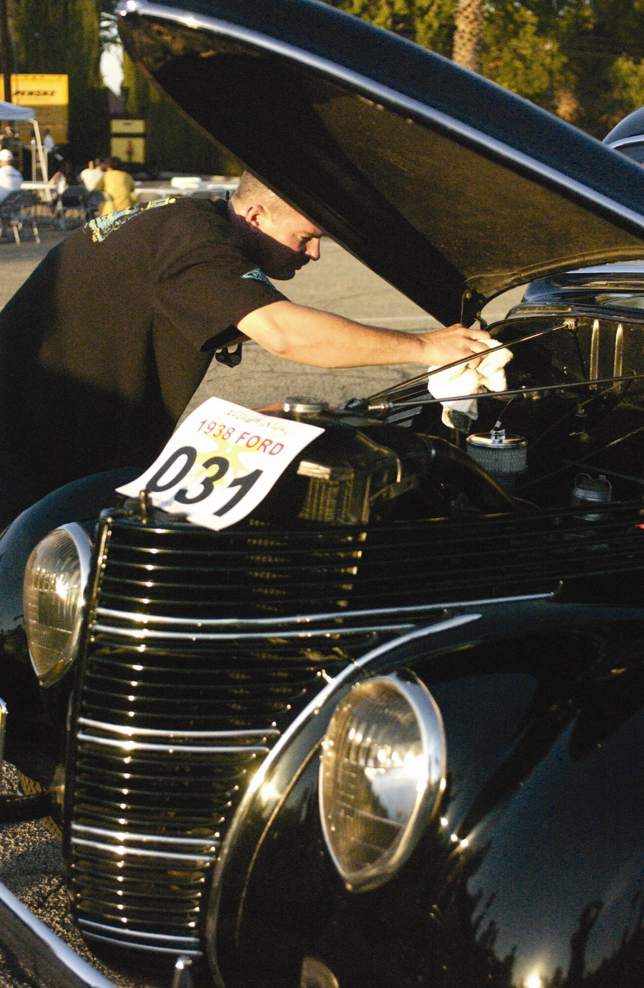 Tech Sgt. Mark Ellis, 452nd Aircraft Maintenance Squadron, does a little last minute polishing to his 1938 Ford which was featured with many other vehicles in the car show. The 452nd Services Squadron hosted the first  Autumn Nights Car Show and Chili Cook-Off Nov. 3. Hundreds of people showed up to LeMay Park to take part in the celebration. For the Chili Cook-Off, the 452nd Fire Department took first place with their smokin’ chili recipe. The 452nd Communications Squadron came in second place and Tahlia Wesley, representing the Army Family Readiness group, took home third. The guests wandered around looking at the various cars on display as well as enjoyed the live entertainment. Food and beverages were also served at the event. The services squadron plans on making this the first of many more Autumn Nights to come. (U.S. Air Force photos by Staff Sgt.Amy Abbott)