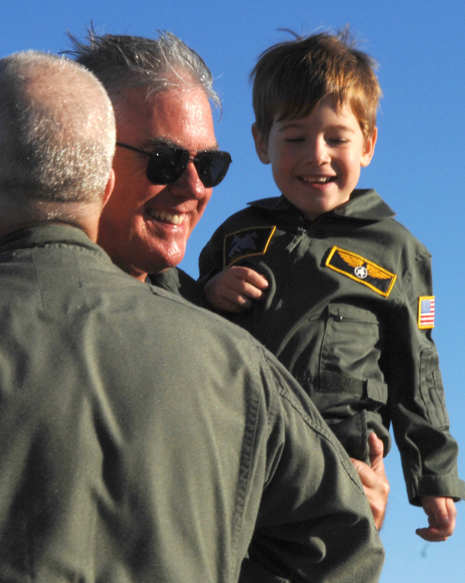 Lt. Gen. Michael Wooley, Air Force Special Operations Command commander, holds his four-year-old grandson, Jackson LeBleu, following the general's finis, or final, flight Nov. 15 at Hurlburt Field, Fla. General Wooley will relinquish command of AFSOC to Maj. Gen. Donnie Wurster Nov. 27. and will retire later this year after 35 years of service. (U.S. Air Force Photo/Senior Airman Stephanie Jacobs)