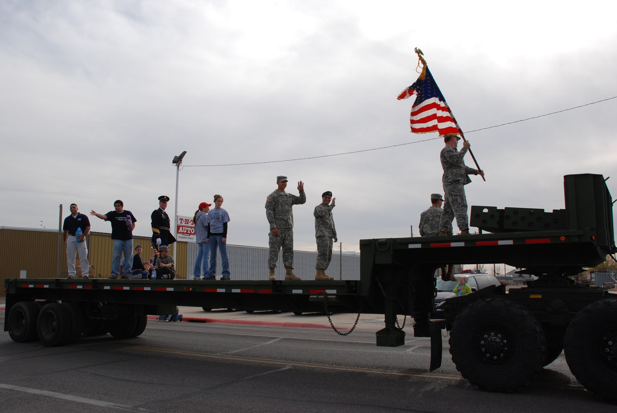 Members of the Nebraska Army National Guard wave to parade attendees from their flatbed truck Nov. 10 during the Scottsbluff, Neb., Veterans Day parade (Photo by 2nd Lt. Lisa Meiman).