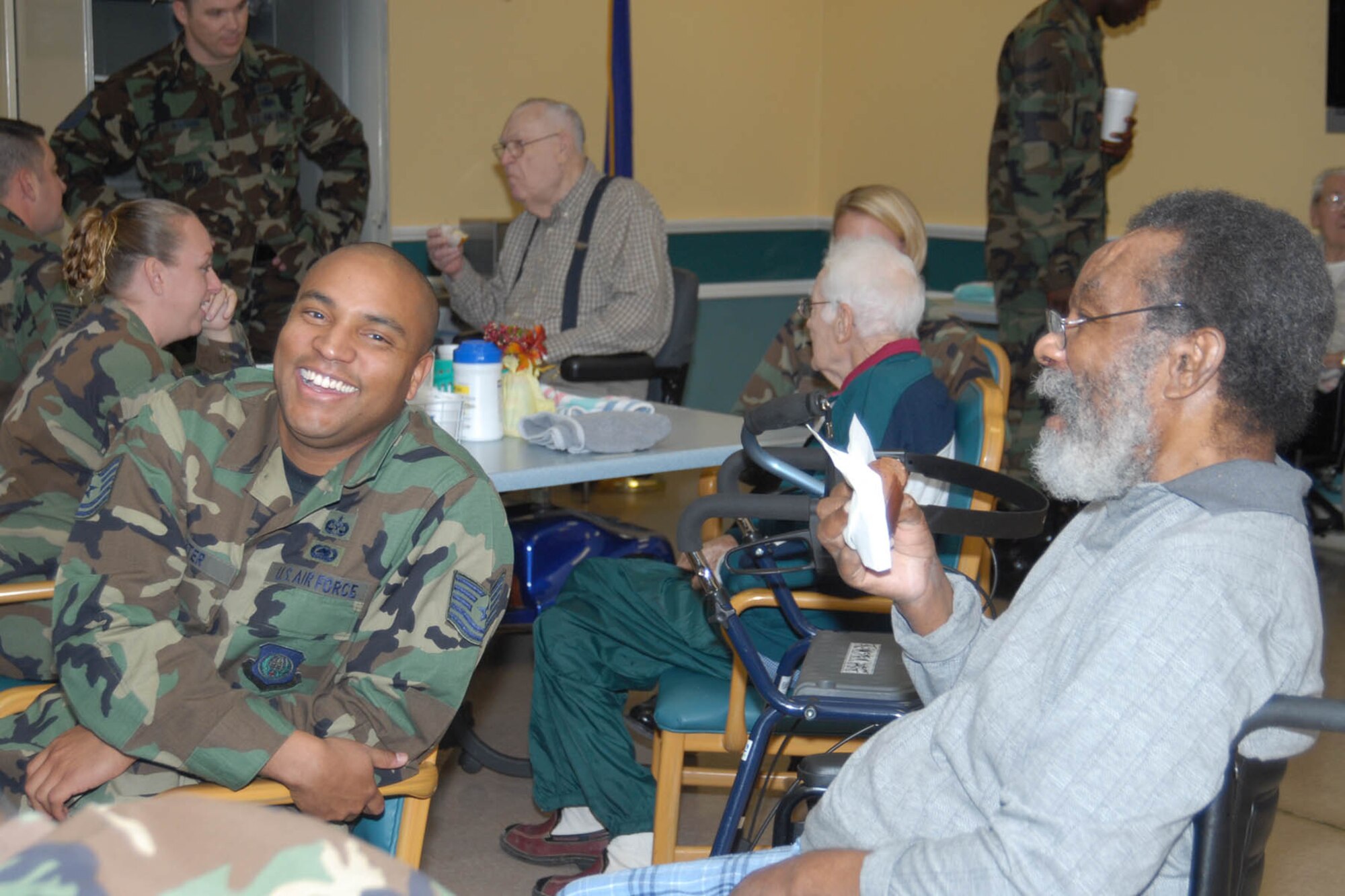 Warren military members visited the Cheyenne Veterans Affiars Medical Center Nov. 8. Tech. Sgt. Waverly Carter, Twentieth Air Force, shares a laugh with retired Army sergeant Winn Merboil (Photo by Shelley Raffl).