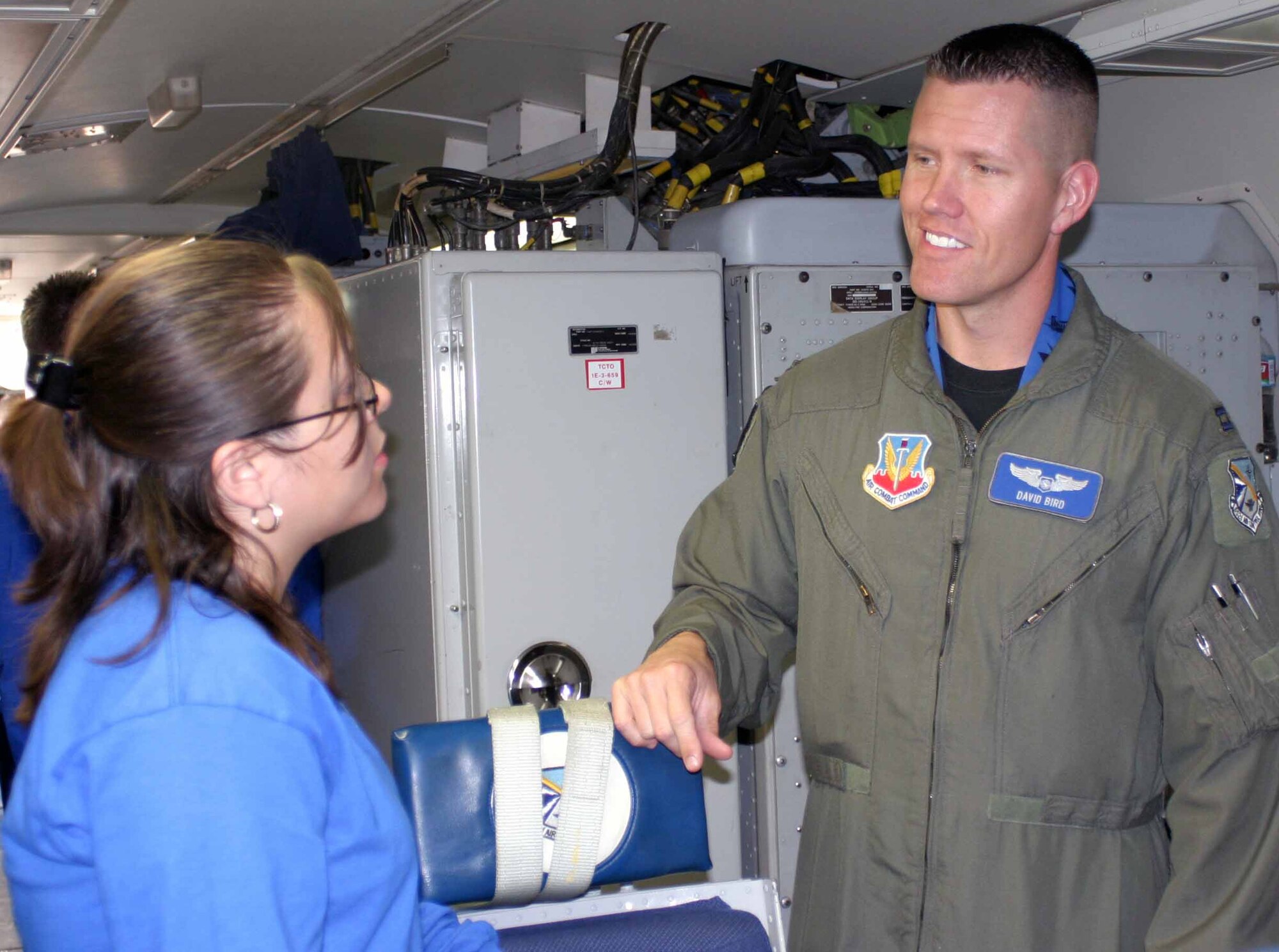 Capt. David R. Bird, 966th Airborne Air Control Squadron, teaches Ana Flores about being an air weapons officer. Ana is one of 25 gifted high school students from the Del City school district who visited Tinker Nov. 8 as part of the DelQuest Future Leaders of America Program. (Air Force photo by 2nd Lt. Kinder Blacke)