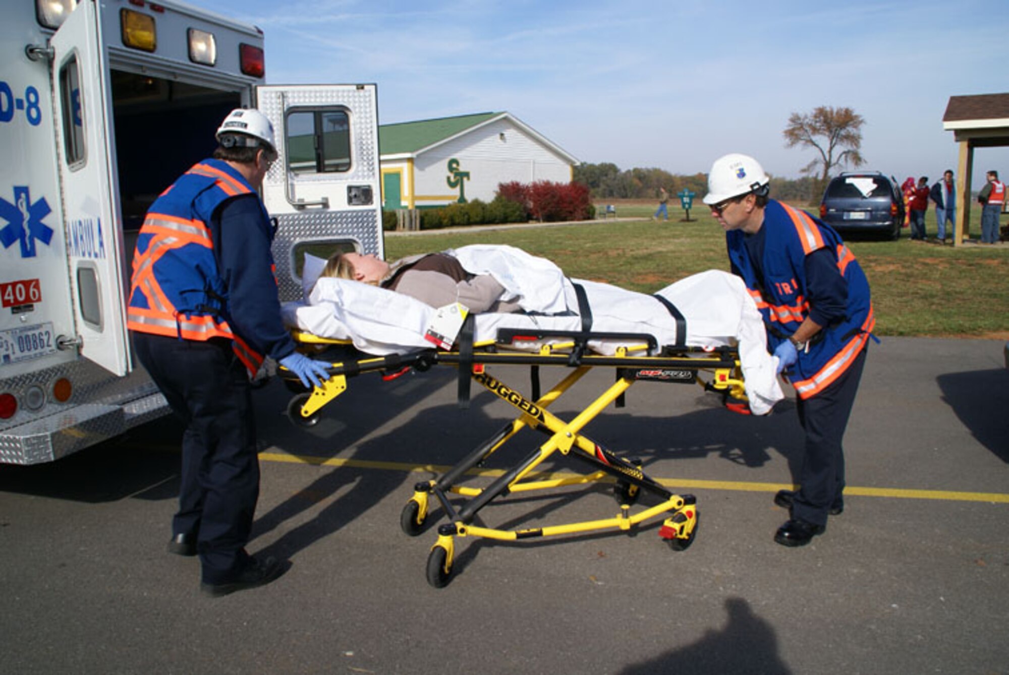 From left, AEDC EMT/Paramedics Dwane Kimmel and Steve Macon transport Amanda Bassett, a senior at Franklin County High School, to Southern Tennessee Medical Center during a mock bus crash in Cowan. (Photo by Philip Lorenz III)