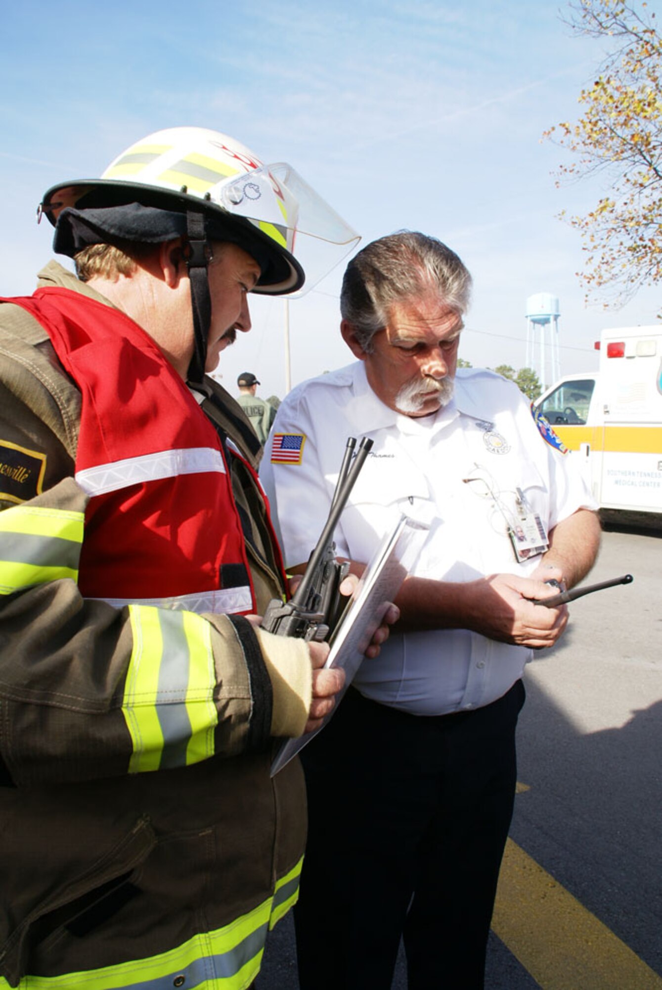 From left, Tommy Myers, Cowan’s fire chief and the incident commander, confers with AEDC Assistant Chief/Training Officer Jeff Thames during a mass casualty training exercise Nov. 10. Mr. Thames was the senior fire officer for Arnold during the event. (Photo by Philip Lorenz III)