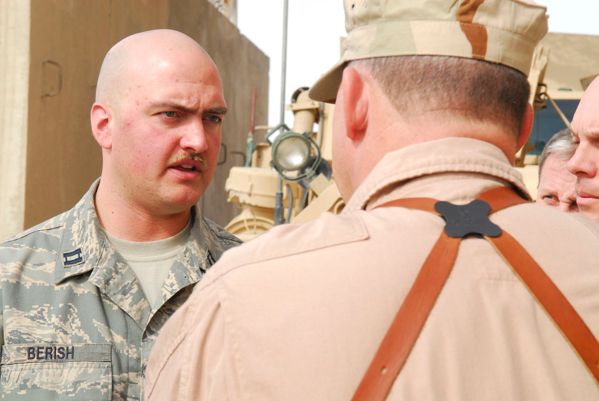 BALAD AIR BASE, Iraq -- Capt. Robert Berish, 332nd Expeditionary Civil Engineer Squadron Explosive Ordinance Disposal Flight commander, talks to Lt. Gen. Gary North, commander of U.S. Central Command Air Forces, about the EOD mission here, Nov. 16.  EOD specialists face the deadly threat of improvised explosive devices on a daily basis. Capt Berish is deployed from Royal Air Force Lakenheath, England. (U.S. Air Force photo/Staff Sgt. Joshua Garcia)