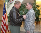 MINOT AIR FORCE BASE, N.D. -- Col. Joel Westa (left), 5th Bomb Wing commander, pins an Air Force Combat Action Medal on Lt. Col. Jimmy Sterling, 5th Medical Support Squadron commander, for his courageous efforts while deployed to Iraq. The colonel was one of two Airmen here to recently receive the award. (U.S. Air Force photo by Airman 1st Class Joe Rivera)