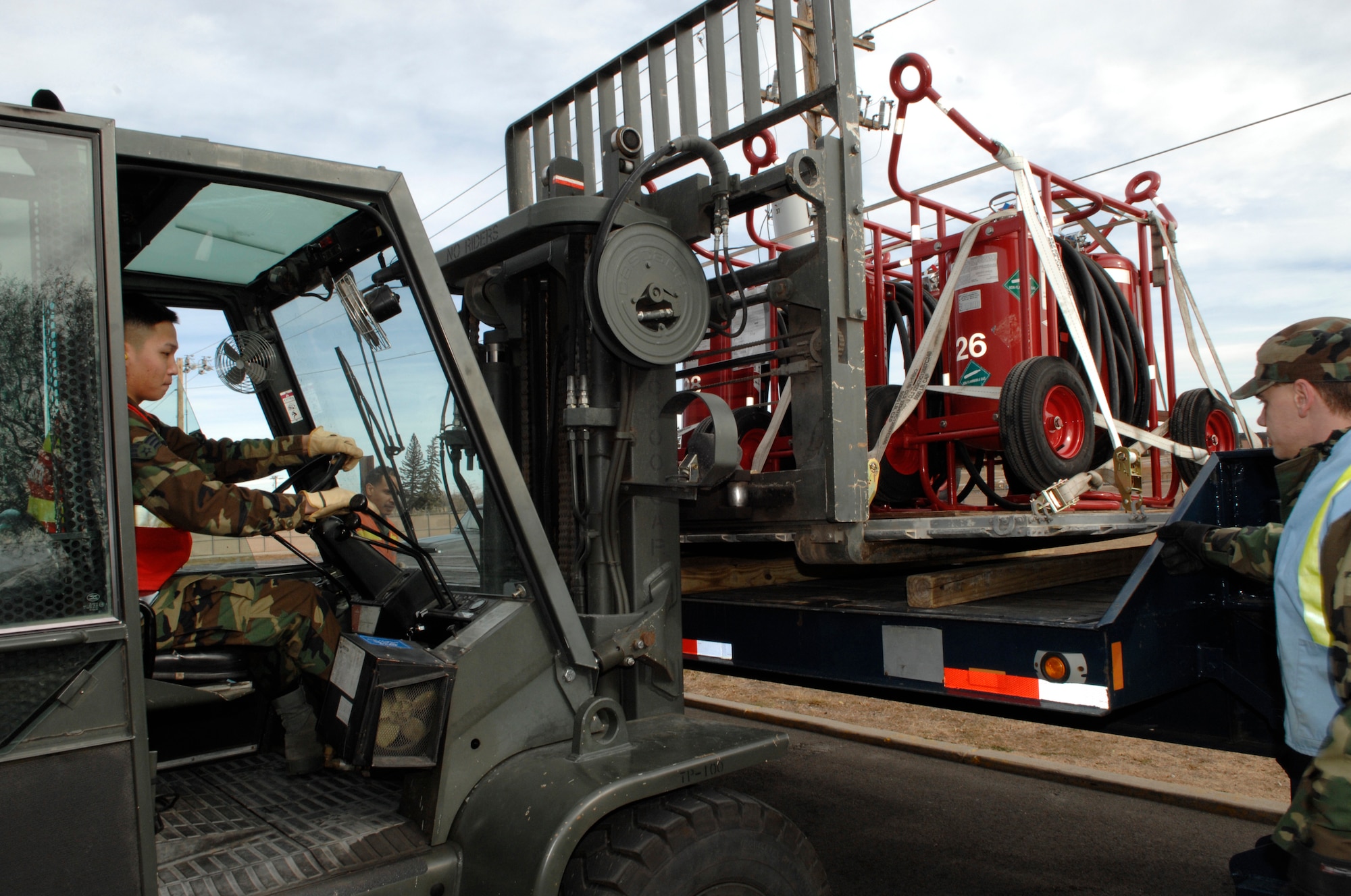 Senior Airman Steven Wachlin, 28th Services Squadron, marshals in cargo off a vehicle while the vehicle operator, Staff Sgt. Jerry Thomason, 28th Logistic Readiness Squardon, stands by the vehicle during an operational readiness inspection at Ellsworth Air Force Base, S.D., Nov. 15, 2007. The cargo deployment function is responsible for ensuring all cargo is properly documented and secured for transportation. (U.S. Air Force photo/Senior Airman Angela Ruiz)

