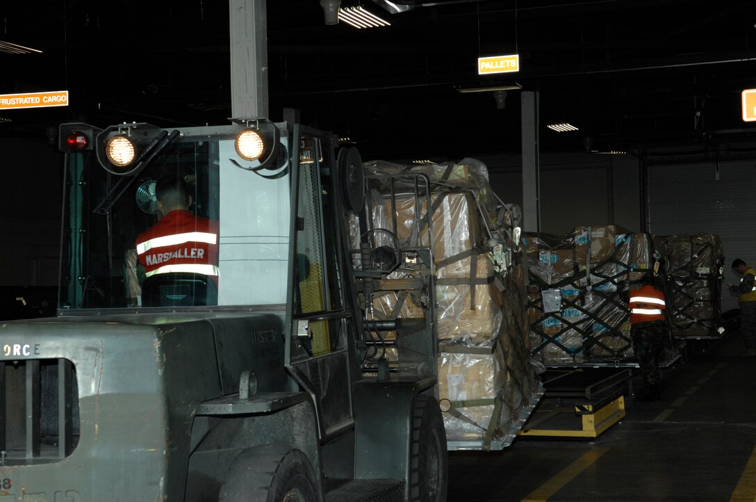 Senior Airman Steven Wachlin, 28th Services Squadron, marshals in cargo during an operational readiness inspection at Ellsworth Air Force Base, S.D., Nov. 15, 2007. The cargo deployment function is responsible for ensuring all cargo is properly documented and secured for transportation. (U.S. Air Force photo/Senior Airman Angela Ruiz)
