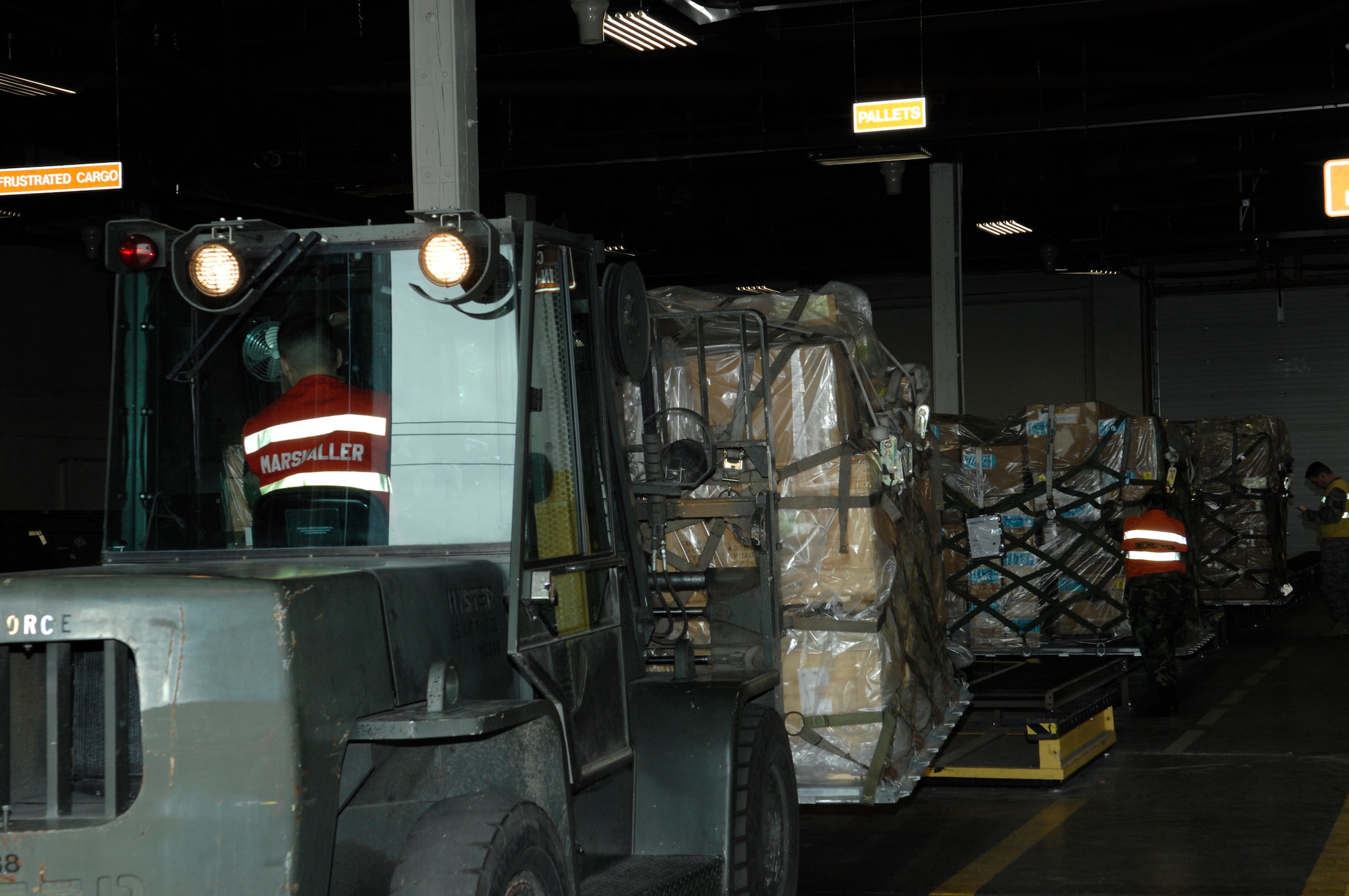 Senior Airman Steven Wachlin, 28th Services Squadron, marshals in cargo during an operational readiness inspection at Ellsworth Air Force Base, S.D., Nov. 15, 2007. The cargo deployment function is responsible for ensuring all cargo is properly documented and secured for transportation. (U.S. Air Force photo/Senior Airman Angela Ruiz)
