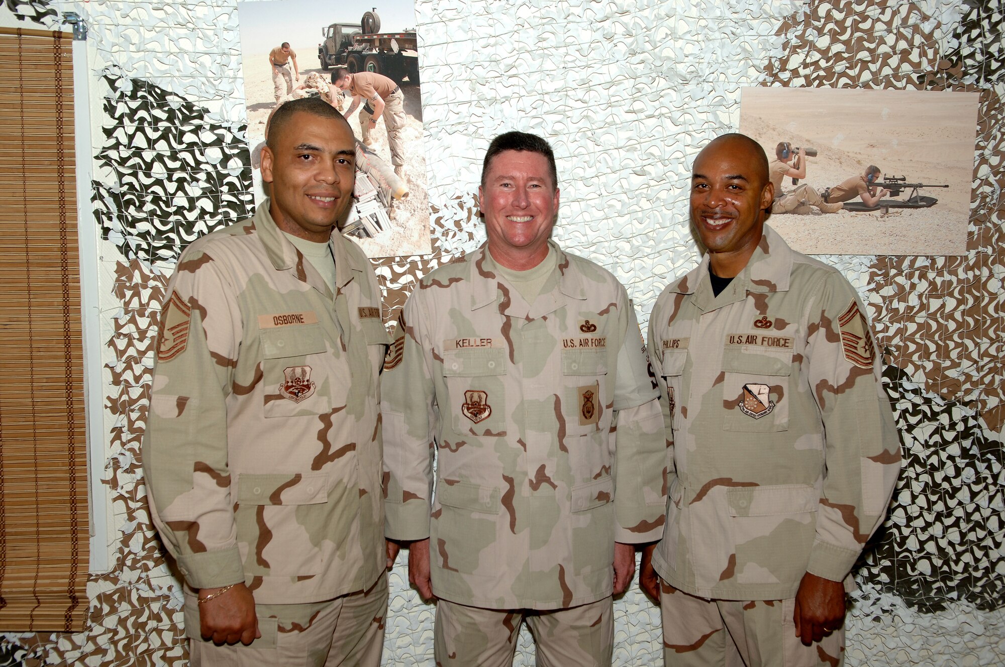 SOUTHWEST ASIA - (From left) Senior Master Sgts. Larry Osborne, 379th Expeditionary Maintenance Group, Ed Keller, 379th Expeditionary Security Forces Squadron, and Rodney Phillips, 379th Expeditionary Logistics Readiness Squadron are all smiles after learing of their recent selection for promotion to chief master sergeant. Nov. 15 at a base in Southwest Asia. (Air Force Photo/ Master Sgt. Greg Kunkle)