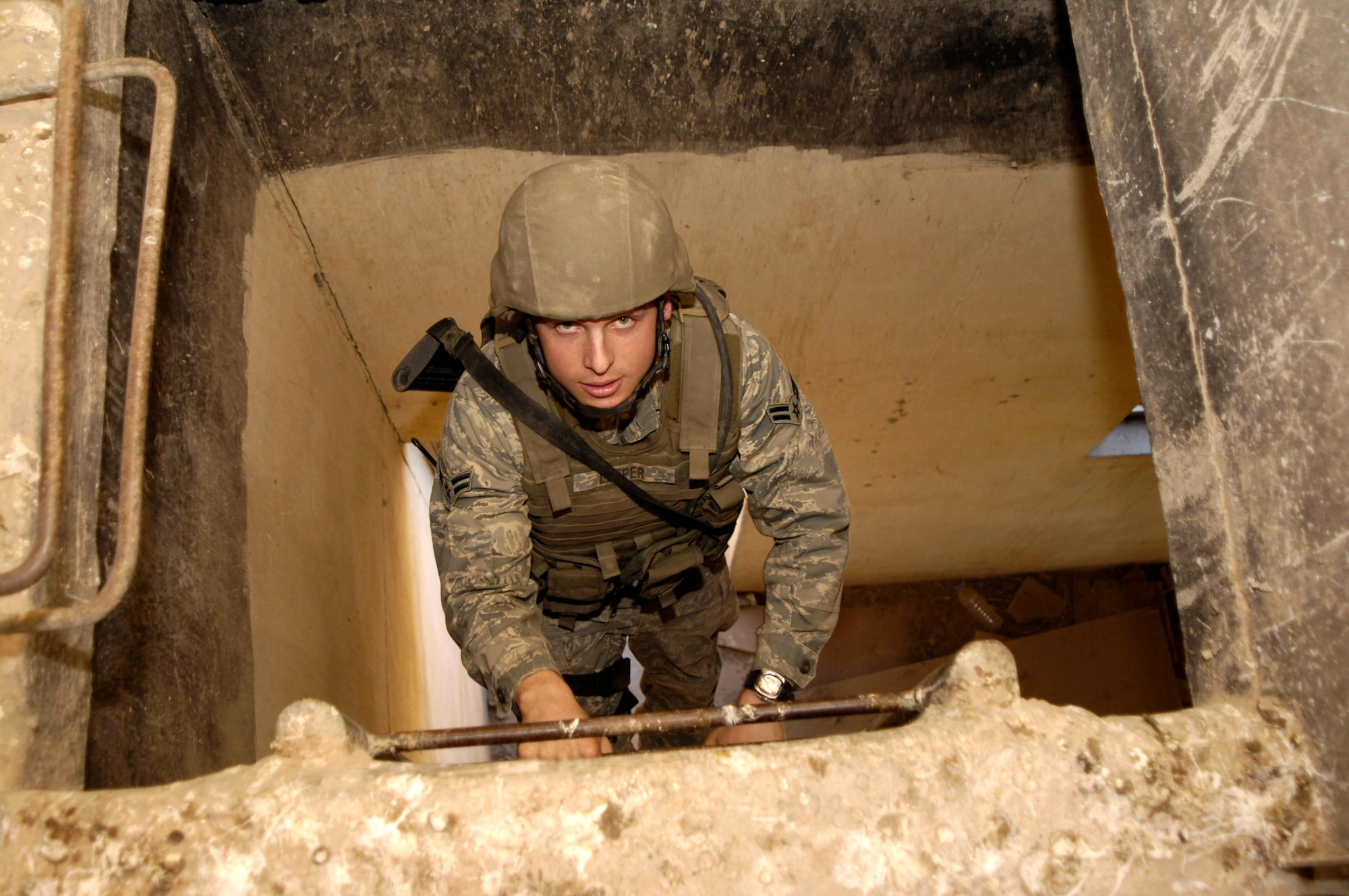 Airman 1st Class Matt Sleeper climbs to the top of a lookout point where his anti-sniper team will set up surveillance for terrorist snipers.  Airman Sleeper is assigned to the 506th Expeditionary Security Forces Squadron at Kirkuk Air Base, Iraq.  (U.S. Air Force official photo/Staff Sgt Angelique Perez)  