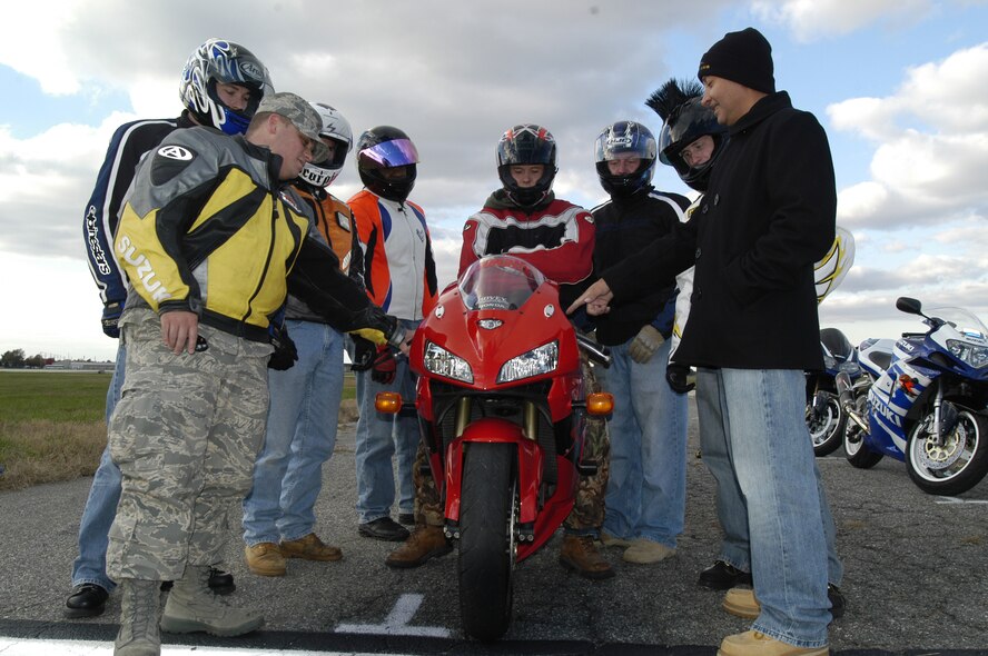 Master Sgt. Jose Ayala and Senior Airman William Landy, sport-bike instructors point out specific areas and give tips of the sport-bikes to the riders in the class. (U.S. Air Force photo/Airman Shen-Chia Chu)