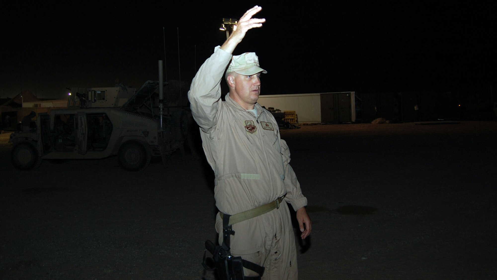 SOUTHWEST ASIA – Master Sgt. Steven Miller, 887th Expeditionary Security Forces convoy commander, gives the signal to move a convoy out Nov. 12 at Camp Bucca, Iraq. Sergeant Miller is from Moody Air Force Base, Ga. (Air Force Photo/Staff Sgt. Phillip Butterfield)


