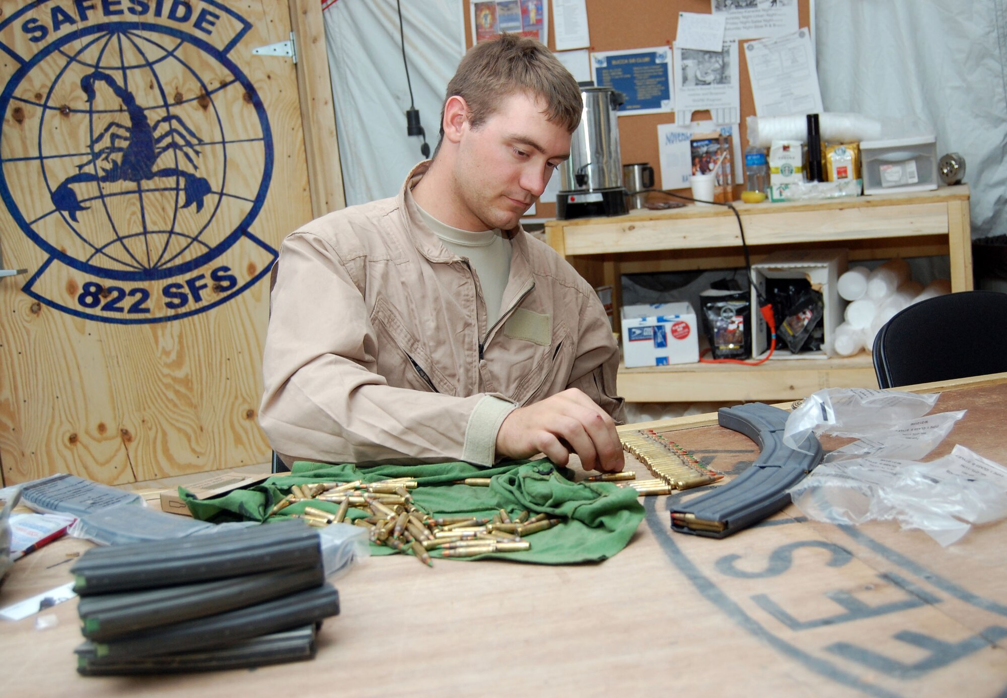 SOUTHWEST ASIA – Airman 1st Class Jason Bearden, 887th Expeditionary Security Forces Cobra Squad fire team member, inspects and fills M-4 carbine magazines before a mission Nov. 12 at Camp Bucca Iraq. Airman Bearden is from Scott Air Force Base, Ill. (Air Force Photo/Staff Sgt. Phillip Butterfield)