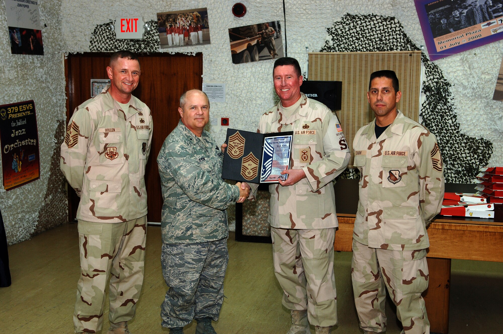 SOUTHWEST ASIA - Senior Master Sgt. Ed Keller, 379th Expeditionary Security Forces Squadron, is presented a certificate of congratulations Nov.15  by Brig. Gen. Charles Lyon, 379th Air Expeditionary Wing commander, for his selection to the grade of chief master sergeant. Standing by are Chief Master Sgts. Lloyd Hollen, 379th AEW command chief and Roger Shaw, 379th Expeditionary Logistics Readiness Squadron. (Air Force photo/Master Sgt. Greg Kunkle)






