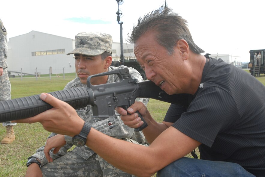 Sgt. Luke Valenzuela, 1-1 Air Defense Artillery Battalion, watches as George Namkung fires an M-16A2 Assualt Rifle during the Joint Civilian Orientation Conference Tour Nov. 9, 2007, at Kadena Air Base, Japan. Approximately 40 distinguished visitors took part in this year's conference which included a week-long tour of military forces in the U.S. Pacific Command. JCOC is a Secretary of Defense-sponsored program for expanding America's leader's knowledge of the military and national defense. JCOC is the oldest existing Pentagon outreach program and has been held more than 73 times since 1948. (U.S. photo/Senior Airman Darnell T. Cannady)