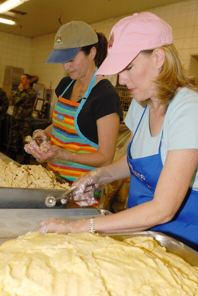 OSAN AIR BASE, Republic of Korea --  Sharon Waller, right, and Kim Norman pan prepare and pan cookies for the Officers' Spouses' Club's annual Cookie Crunch on Nov. 14. (U.S. Air Force photo by Senior Master Sgt. Marvin Krause)