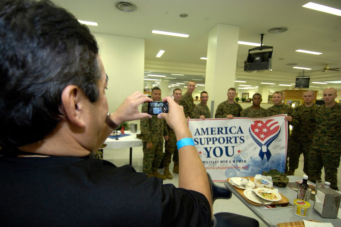 Dr. David F. Jimenez, professor & chairman of the Department of Neurosurgery at the University of Texas Health Science Center in San Antonio, takes a photo of Marines stationed at Camp Hansen, Okinawa, during the 74th Joint Civilian Orientation Conference Nov. 10, 2007.  