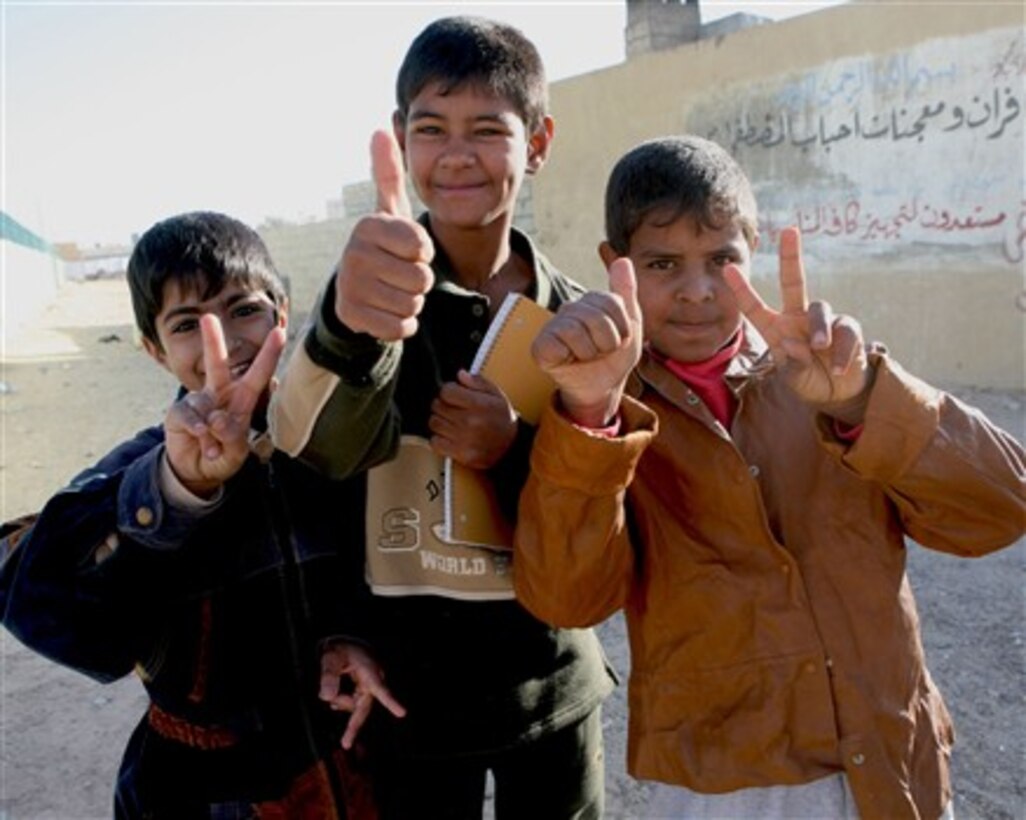Iraqi children pose for a photo in the Ta 'Meem District of Ar Ramadi, Iraq, Nov. 13, 2007.