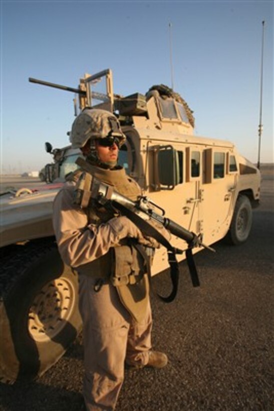 A U.S. Marine with Security Company, Combat Logistics Battalion 8 provides security for his fellow Marines during a stop in the patrol of Mission Supply Route - Michigan outside of Camp Taqaddum, Iraq, on Nov. 5, 2007.  