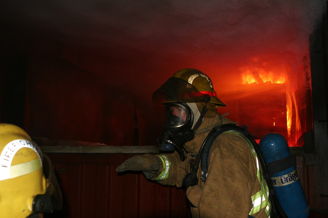 Fire Lieutenant Tom Fowler, CCFD firefighter, instructs other firefighters about the behaviors and dangers of flashovers during live-fire training Saturday.