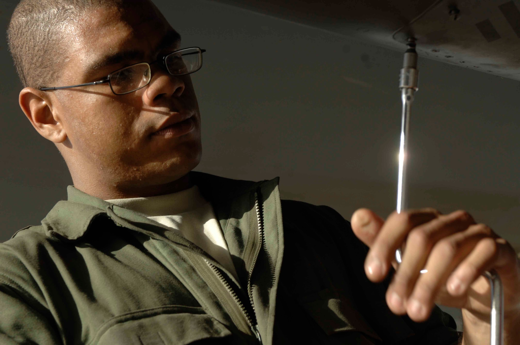 BAGRAM AIR BASE, Afghanistan -- Airman 1st Class Darwin Gellizeau, 455th Expeditionary Maintenance Squadron, opens a panel on a F-15E Strike Eagle during maintenance here, Nov. 17, 2001. (U.S. Air Force Photo by Staff Sgt. Joshua Jasper)(Released)