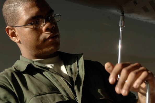 BAGRAM AIR BASE, Afghanistan -- Airman 1st Class Darwin Gellizeau, 455th Expeditionary Maintenance Squadron, opens a panel on an F-15E Strike Eagle during maintenance here, Nov. 17, 2001. Airman Gellizeau is currently deployed from Seymour Johnson Air Force Base, N.C. (U.S. Air Force Photo by Staff Sgt. Joshua Jasper)(Released) 