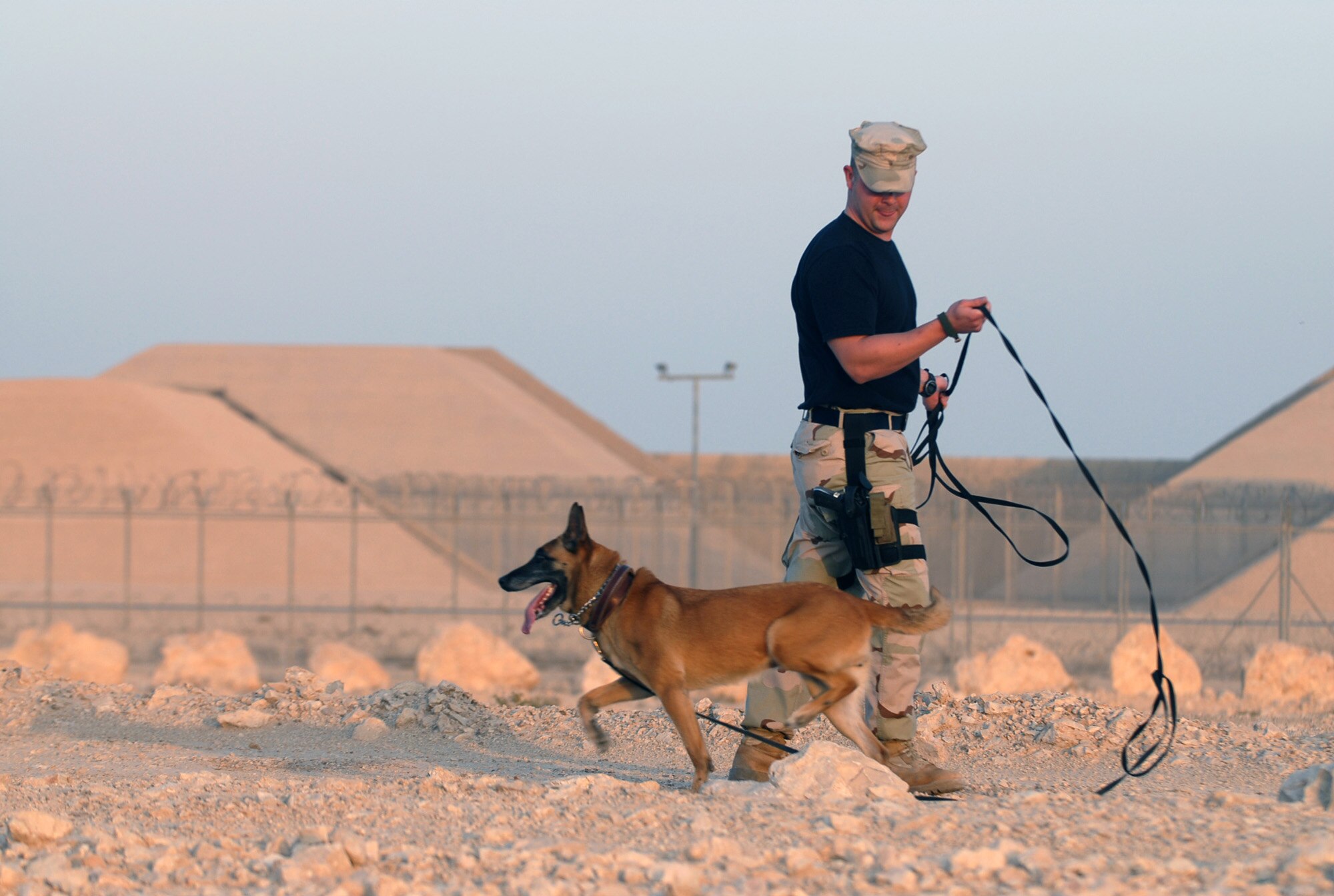 SOUTHWEST ASIA - Staff Sgt. Patrick Felice and his K9 partner, Roxy, work a training course Nov. 14 at a Southwest Asia air base. Sergeant Felice is deployed from the Air Force Academy, Colo.  His partner, Roxy, is five years old.  (U.S. Air Force photo/Staff Sgt. Douglas Olsen)